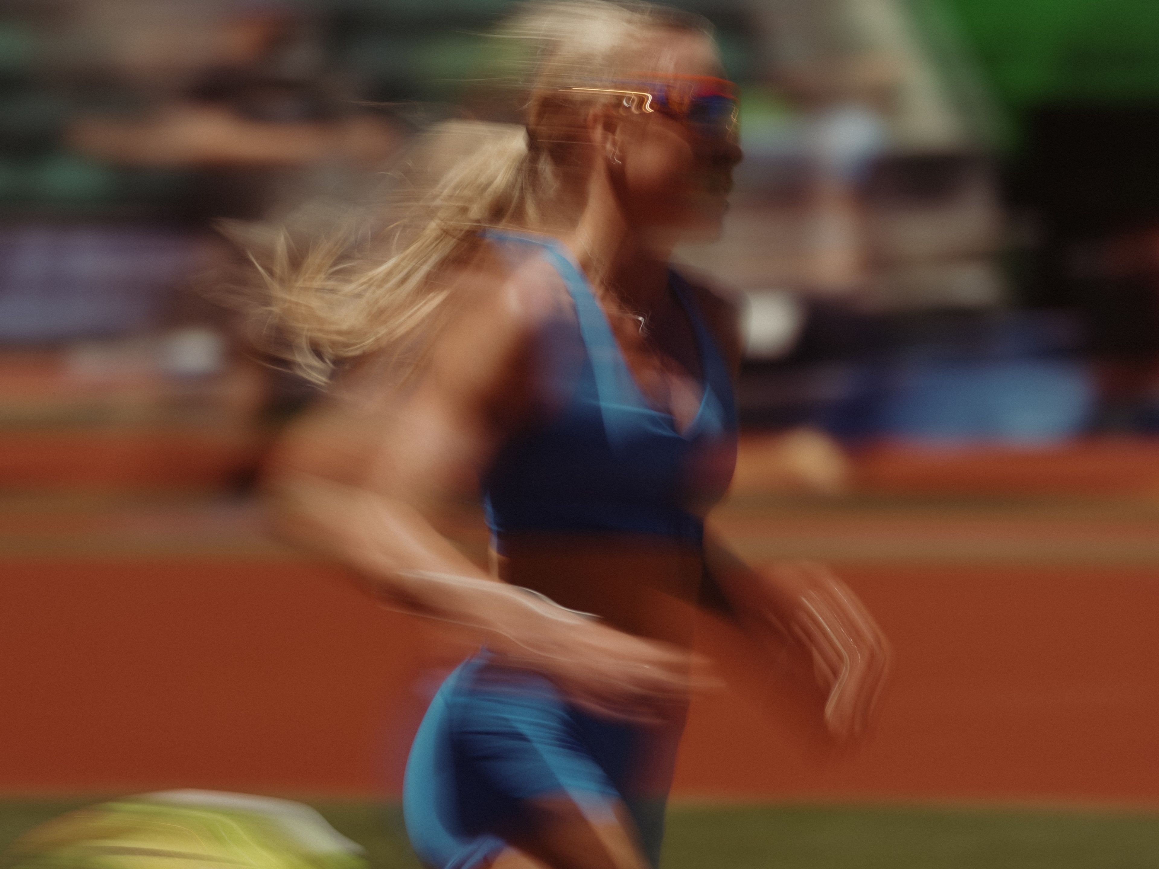 A blurry photo of Keely Hodgkinson running on a track during a race