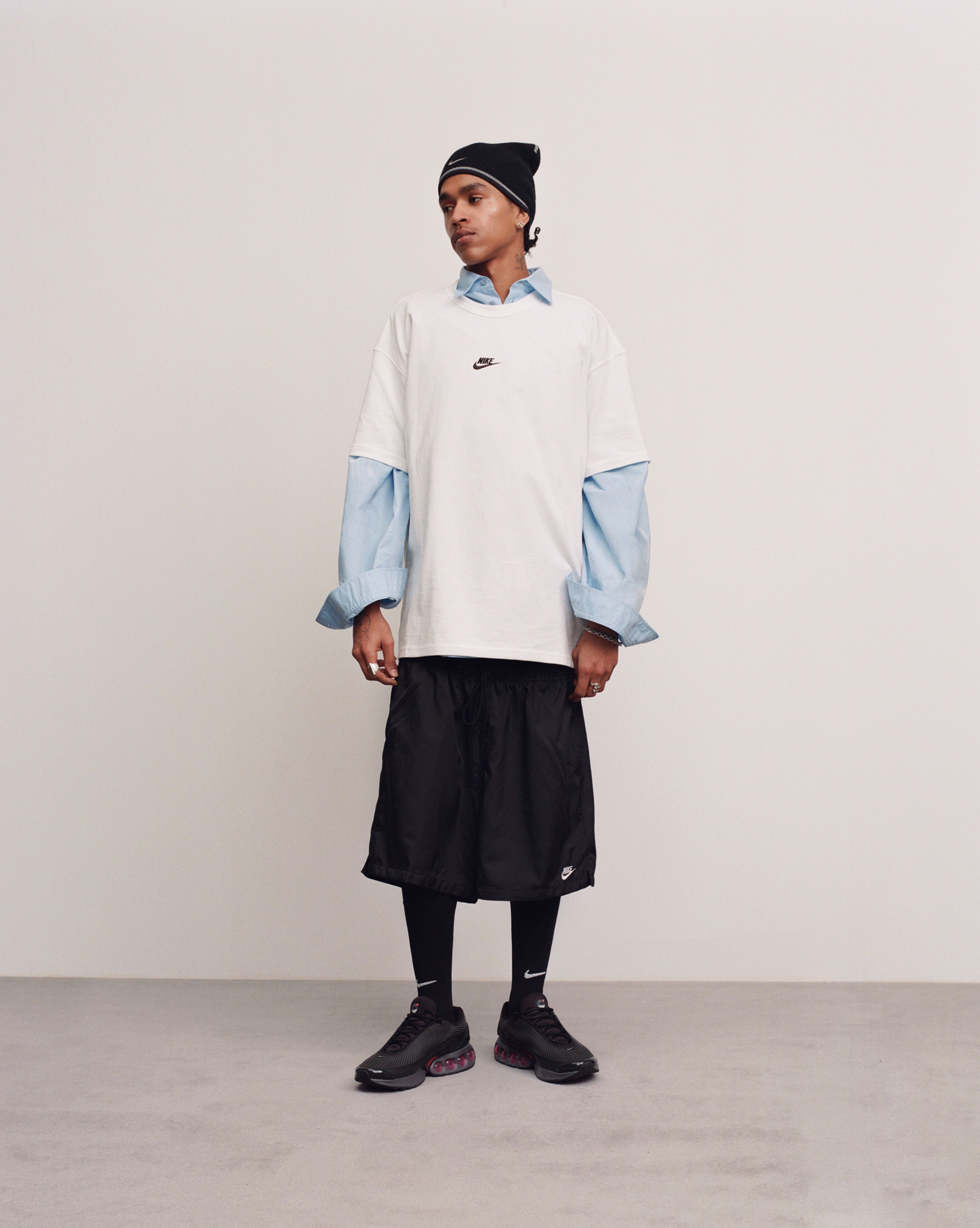 Male model wearing the Nike Air Max Dn in all night colorway while looking to the right