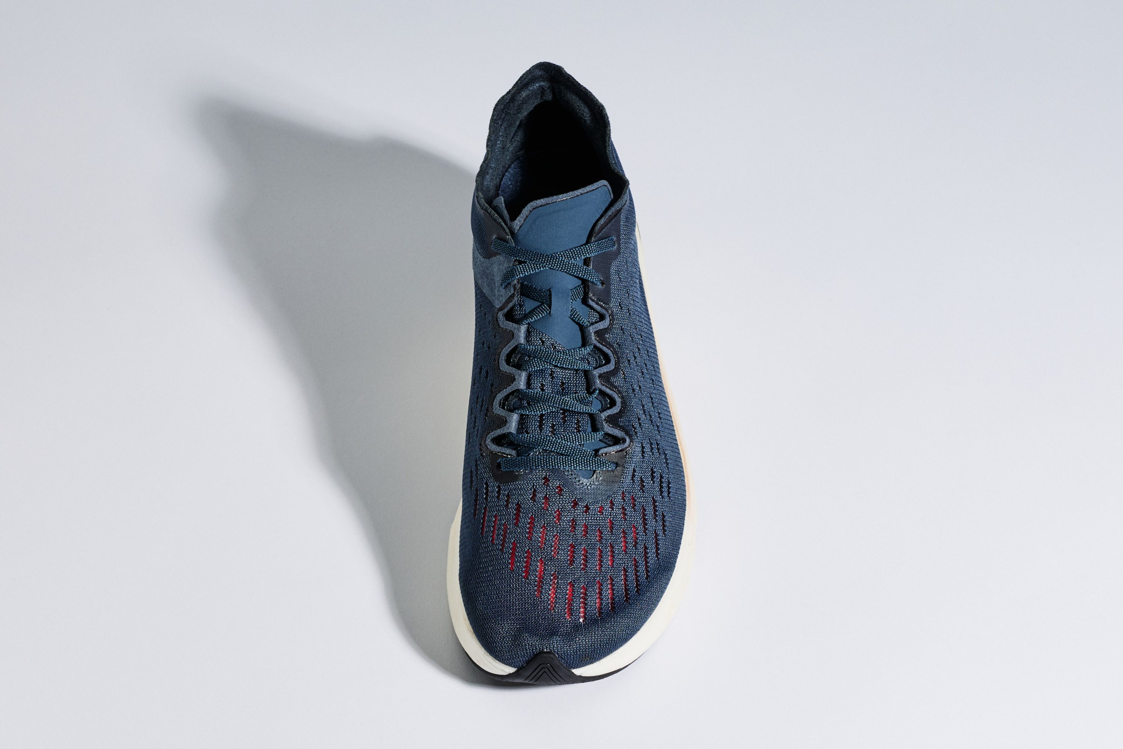 Nike Zoom Vaporfly 4% running shoe with red accents on the toe box, shown from a top-down angle against a light grey background.