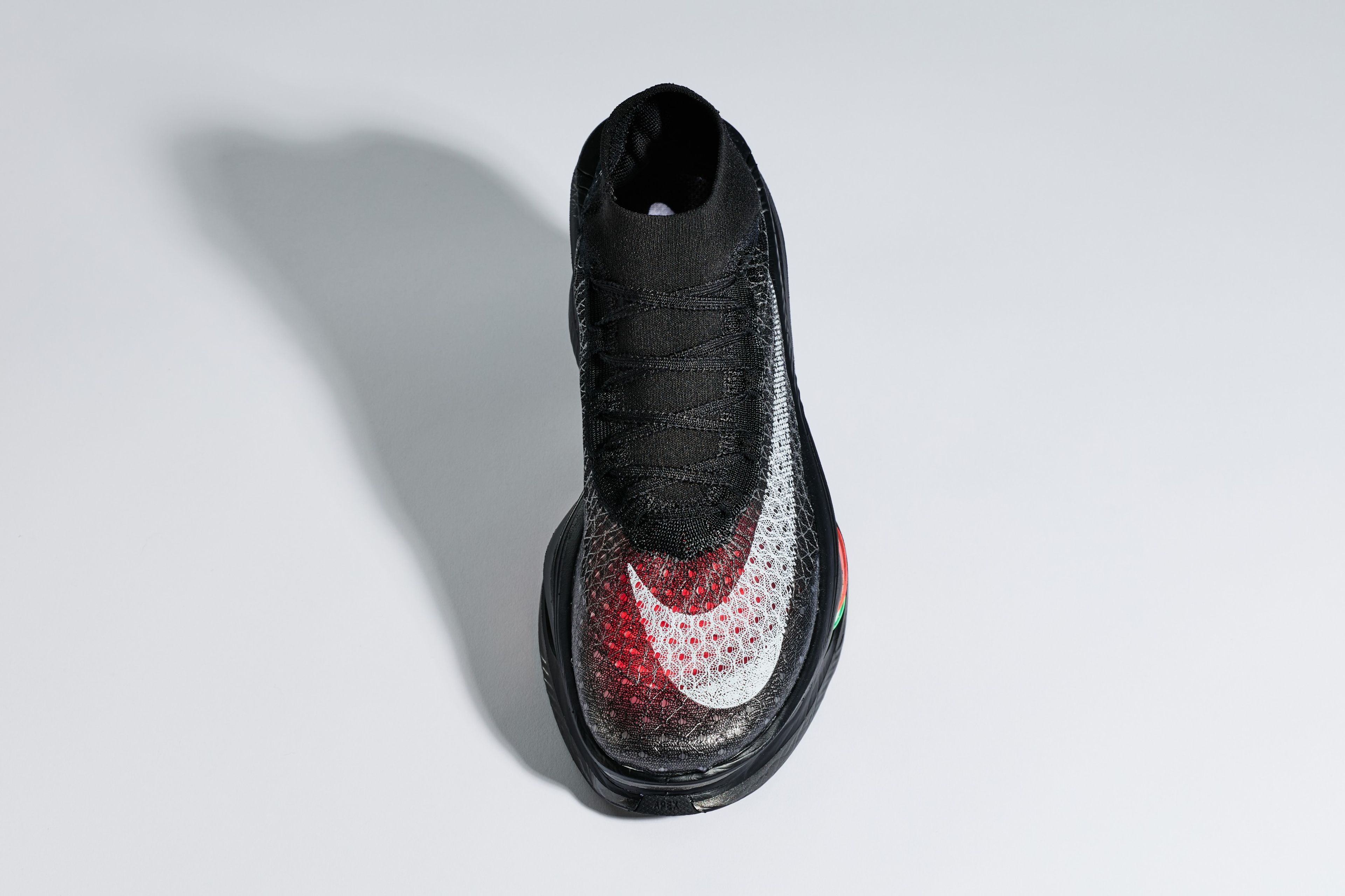 Overhead view of a Nike Apex racing shoe, black colorway with white Swoosh.