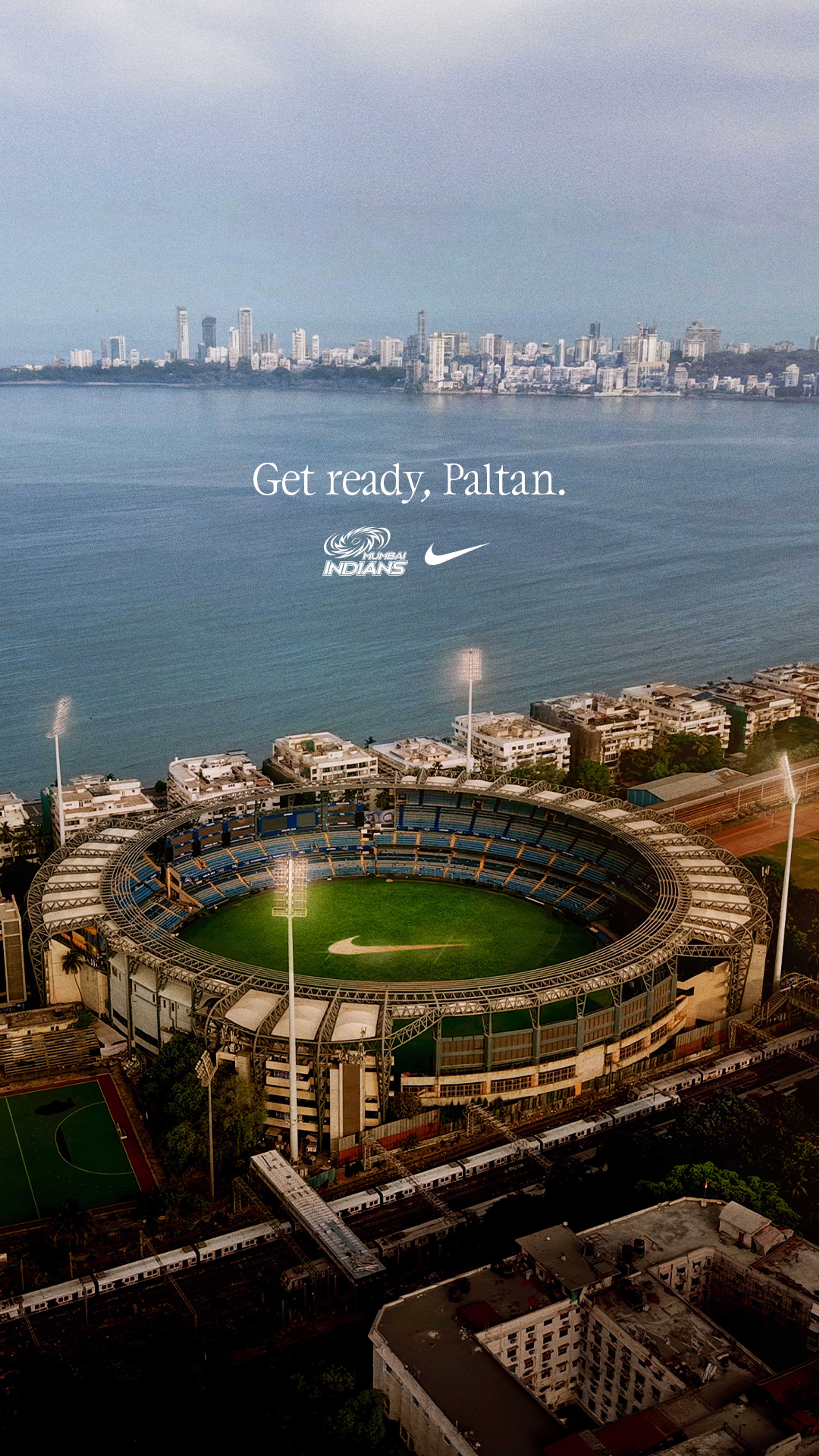 Aerial view of Wankhede Stadium in Mumbai with the Mumbai Indians logo and Nike Swoosh overlaid above