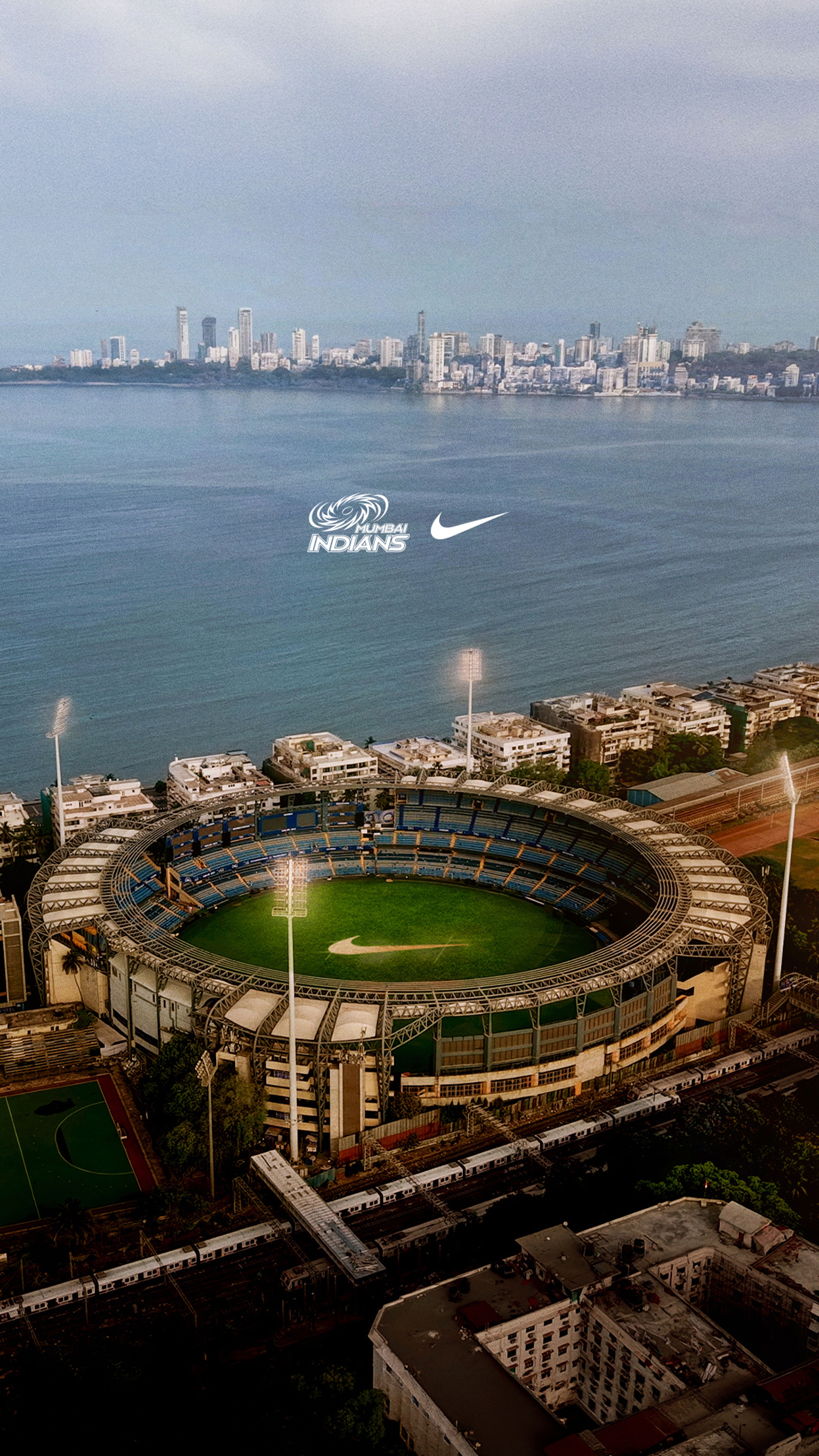 Aerial view of Wankhede Stadium in Mumbai with the Mumbai Indians logo and Nike Swoosh overlaid above