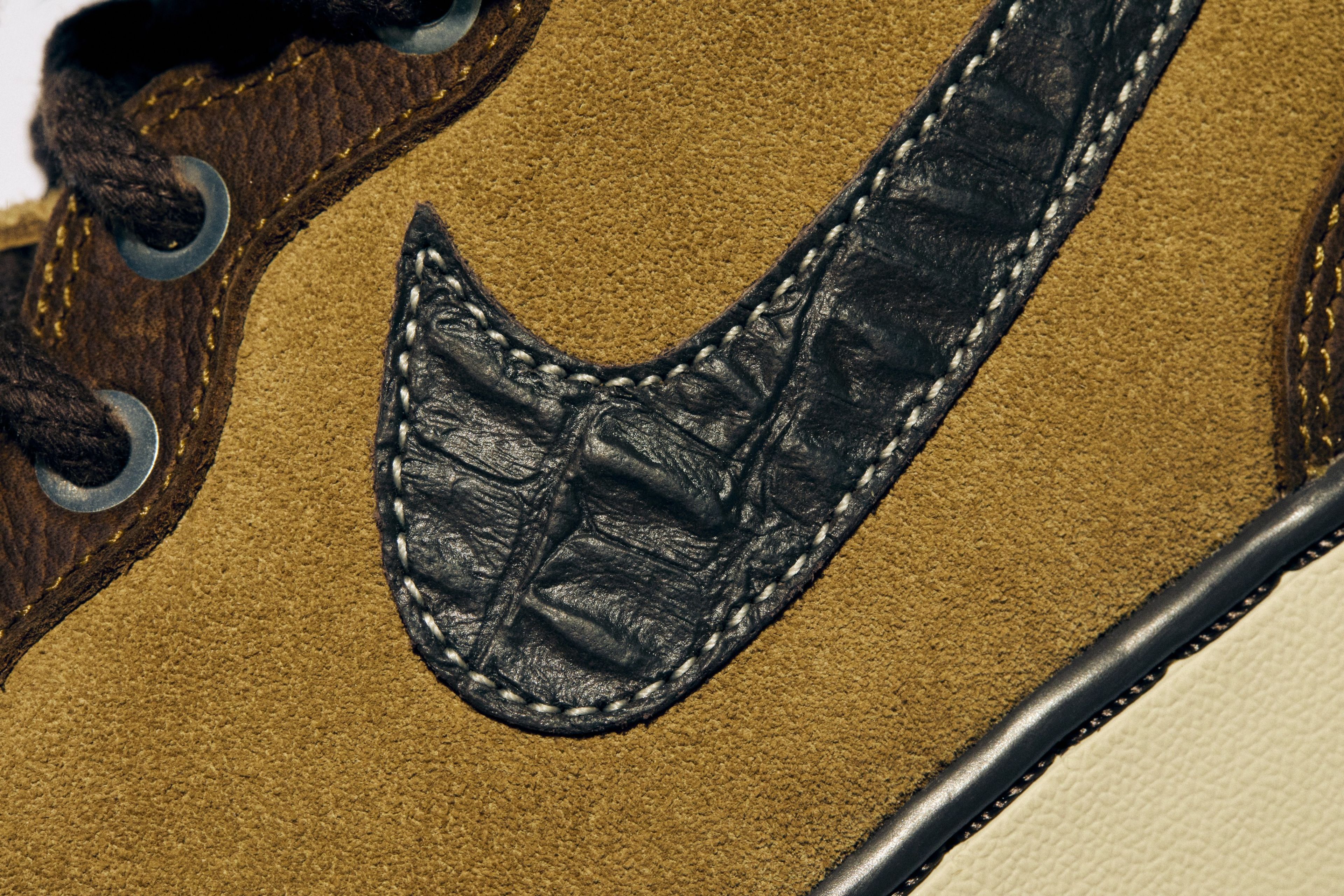 The premium leather upper, croc print Swoosh and stitch pattern on the toe of the Nike Air Force 1 Mid.