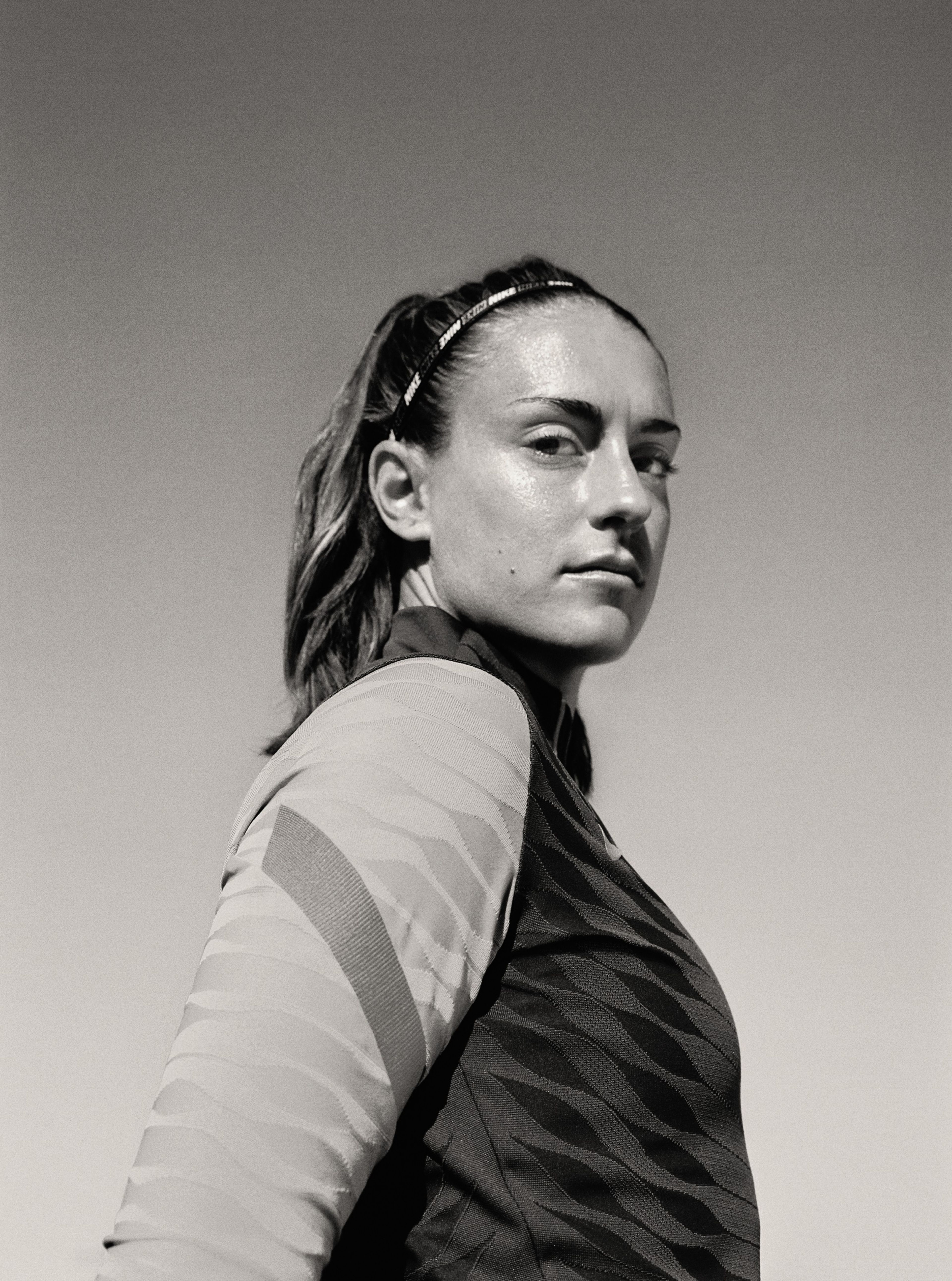Black and white side angled view of Alexia Putellas with a calm expression.
