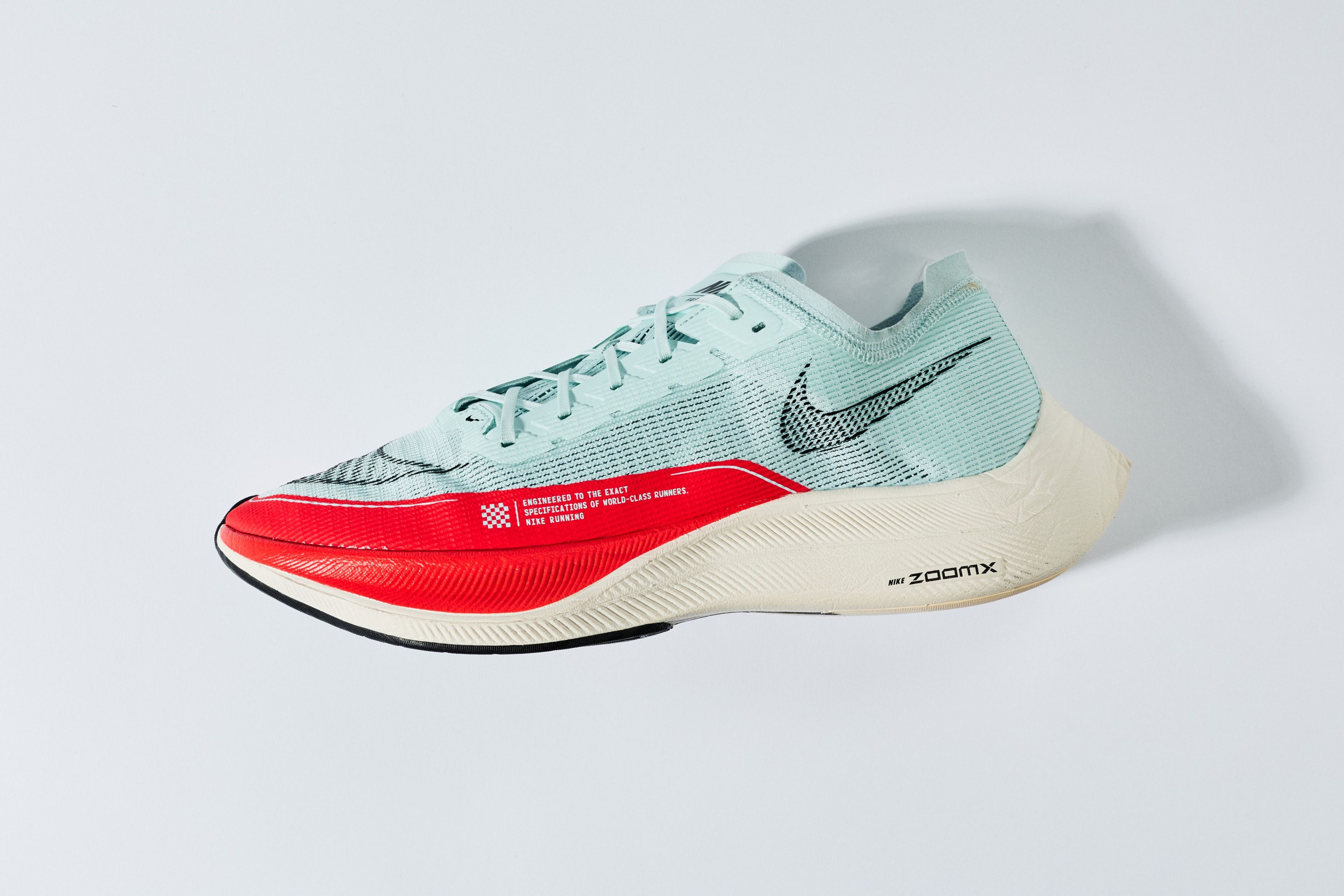 Nike ZoomX Vaporfly Next% 2 running shoe in light blue and red against a clean white background.