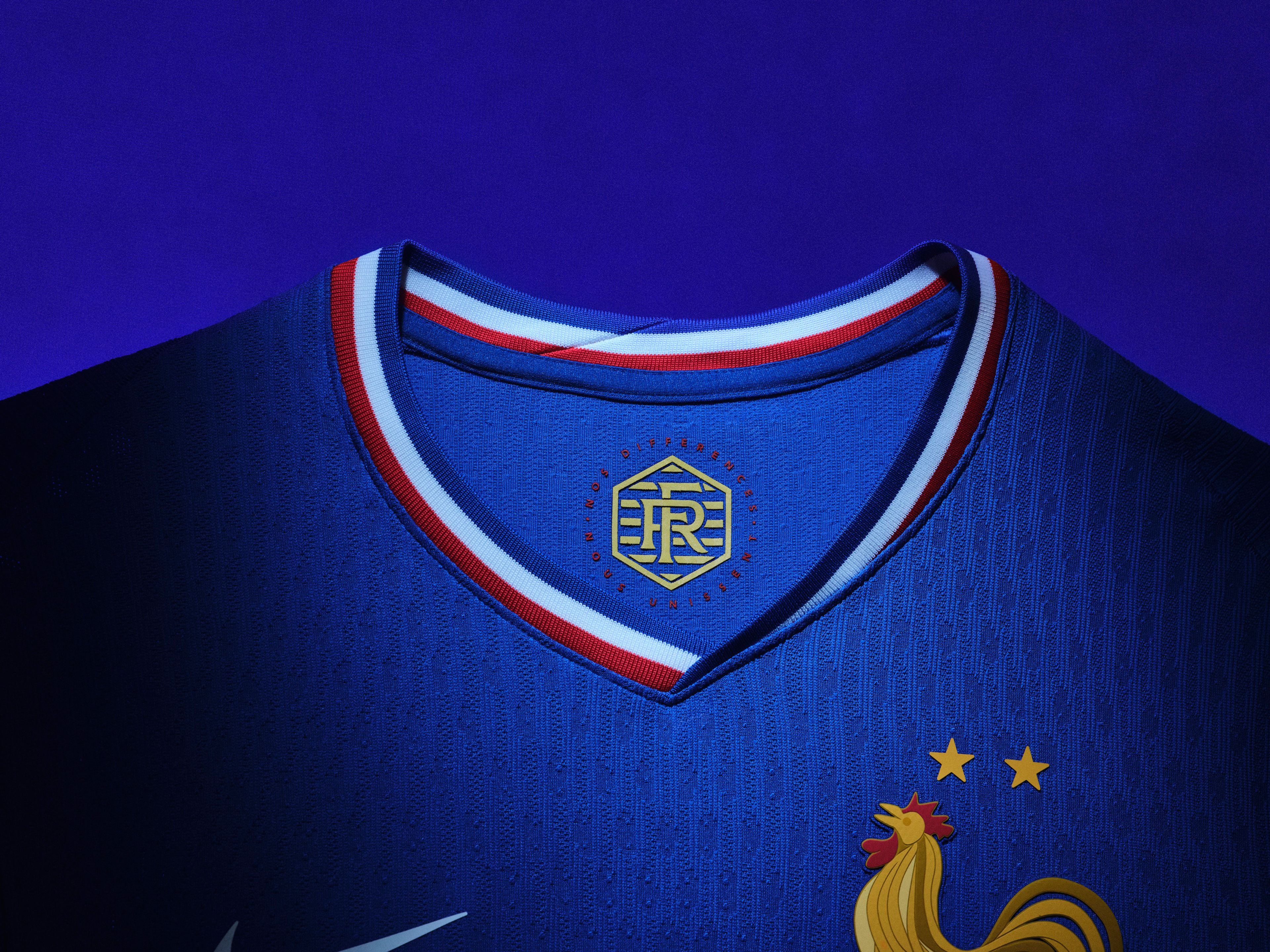 Close up view of the inner collar of a cobalt blue soccer jersey with a red, white, and blue collar and a logo on the back of the collar.