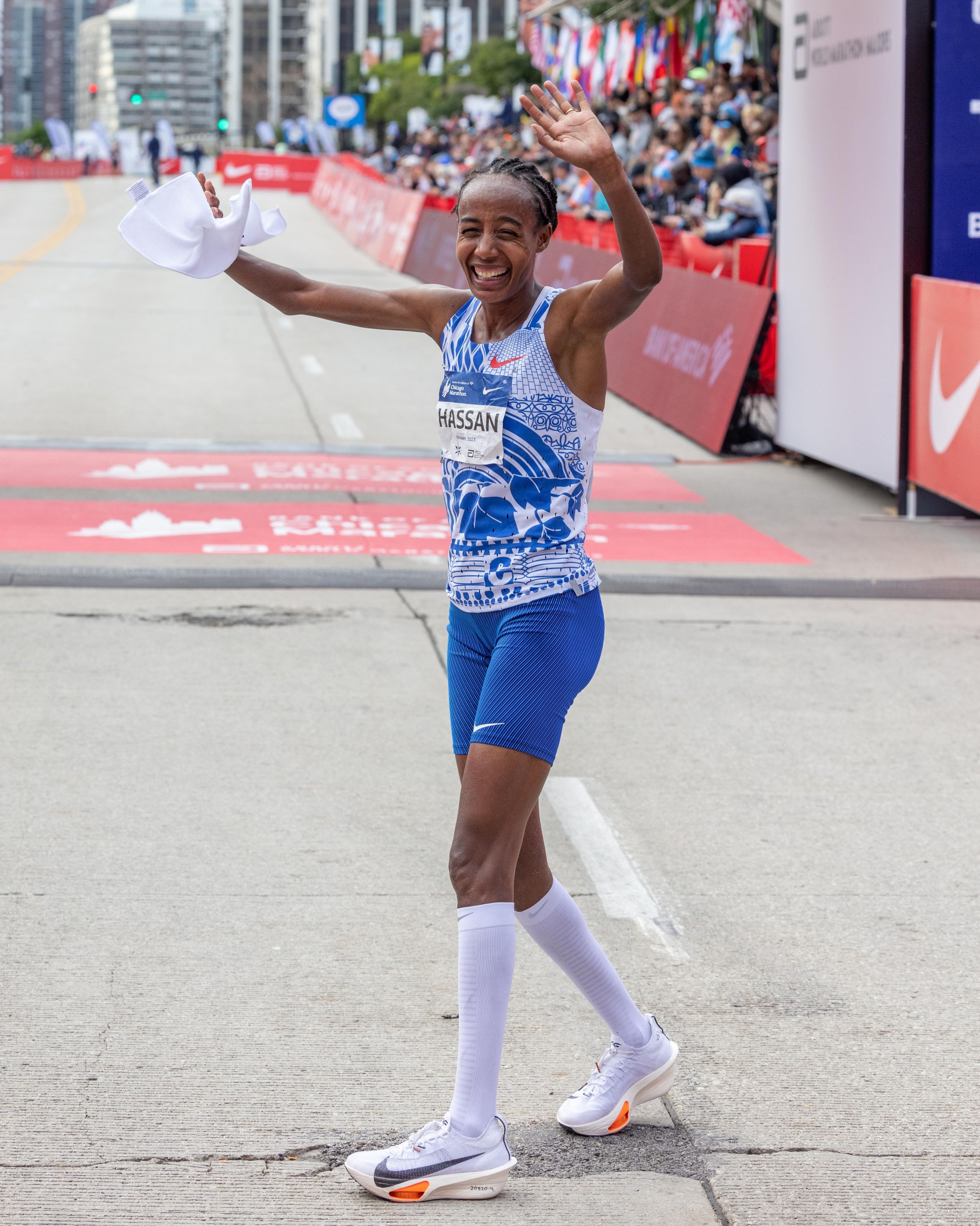 Sifan Hissan wearing the Nike Alphafly 3 and waving at the crowd after running the second fastest women's marathon in history at the 2023 Chicago Marathon.