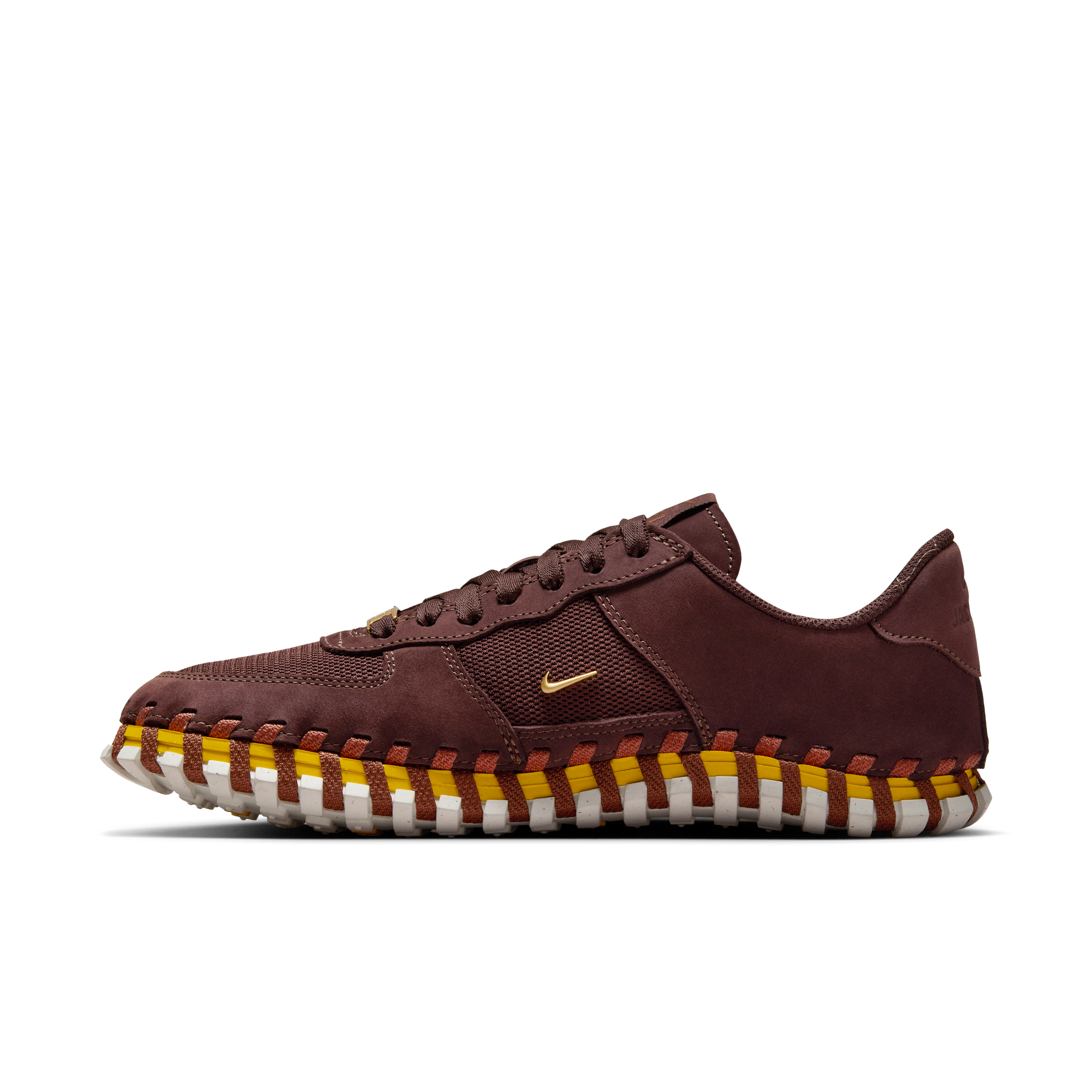 Left view of a Nike x Jacquemus J Force 1 Low LX SP with Earth brown upper, tour yellow midsole, and white sole. Includes, brown laces and AF1 lace tag in gold metal. There is a small metallic gold Swoosh on the shoe's side. The shoe floats on a black background.