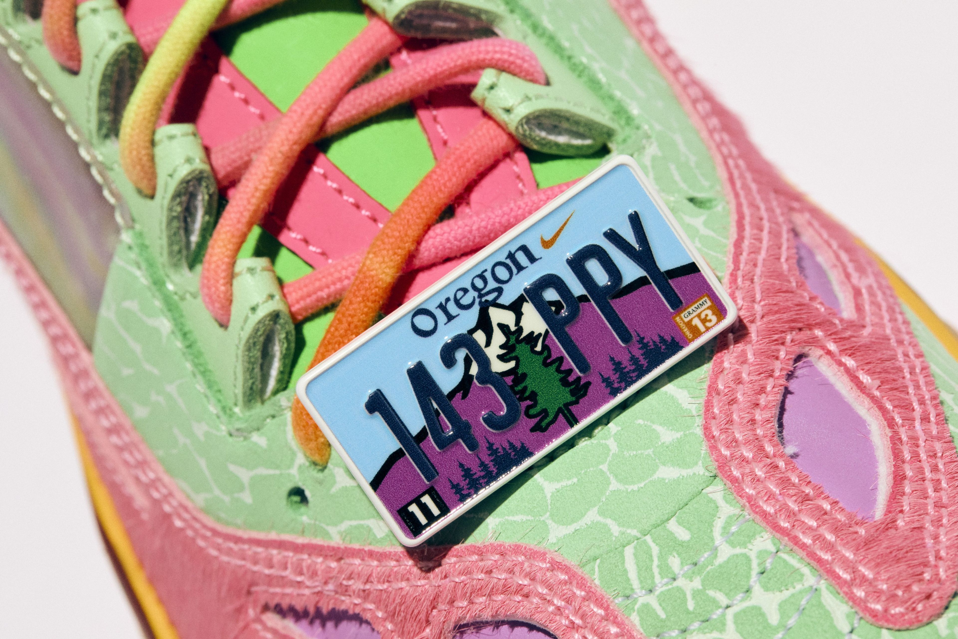 Close-up of a Nike sneaker with an Oregon license plate pin.