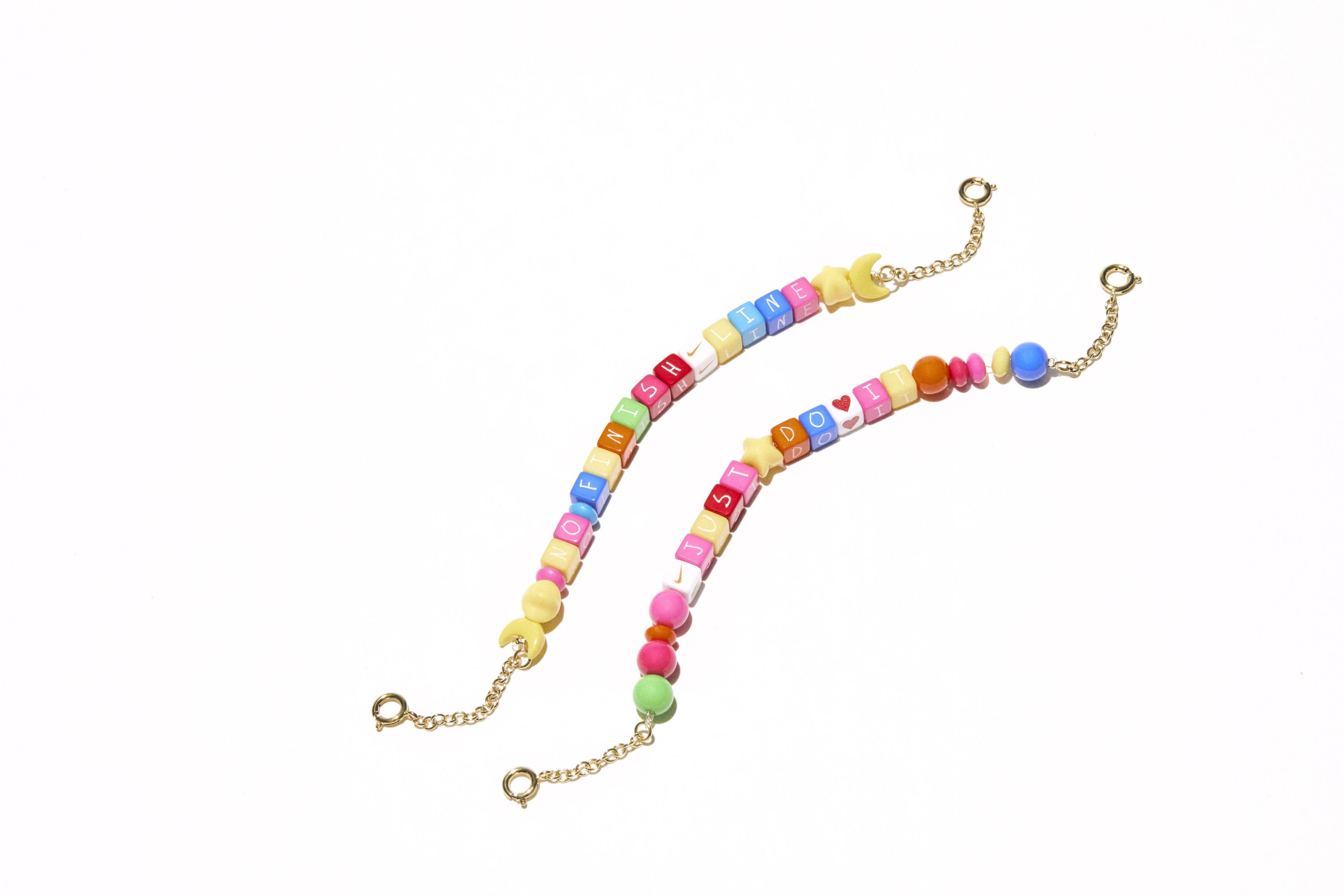 Two Nike multicolor beaded bracelets with letter beads.