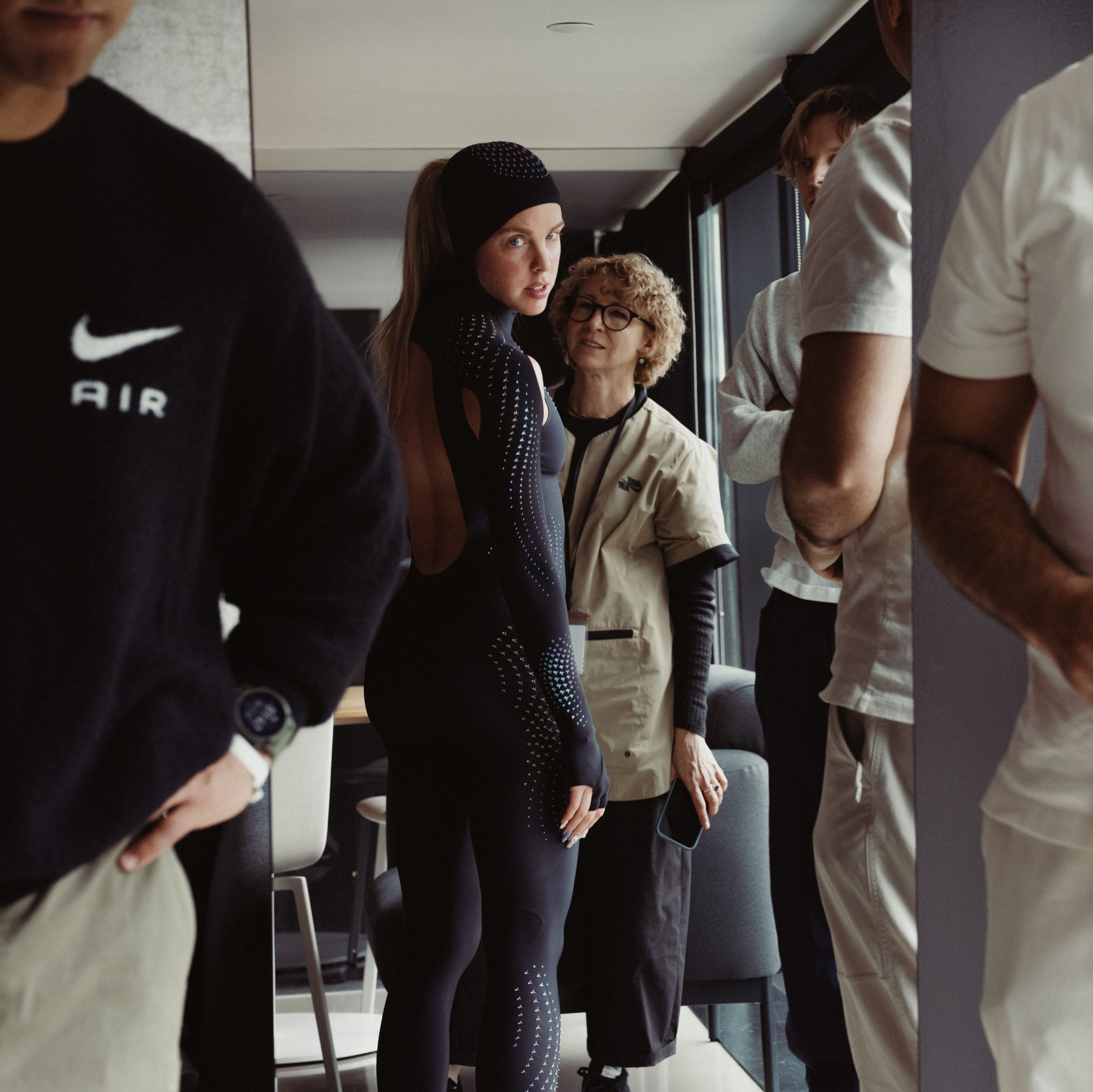 Keely Hodgkinson looks toward the camera while being fitted for a black full-body speed suit