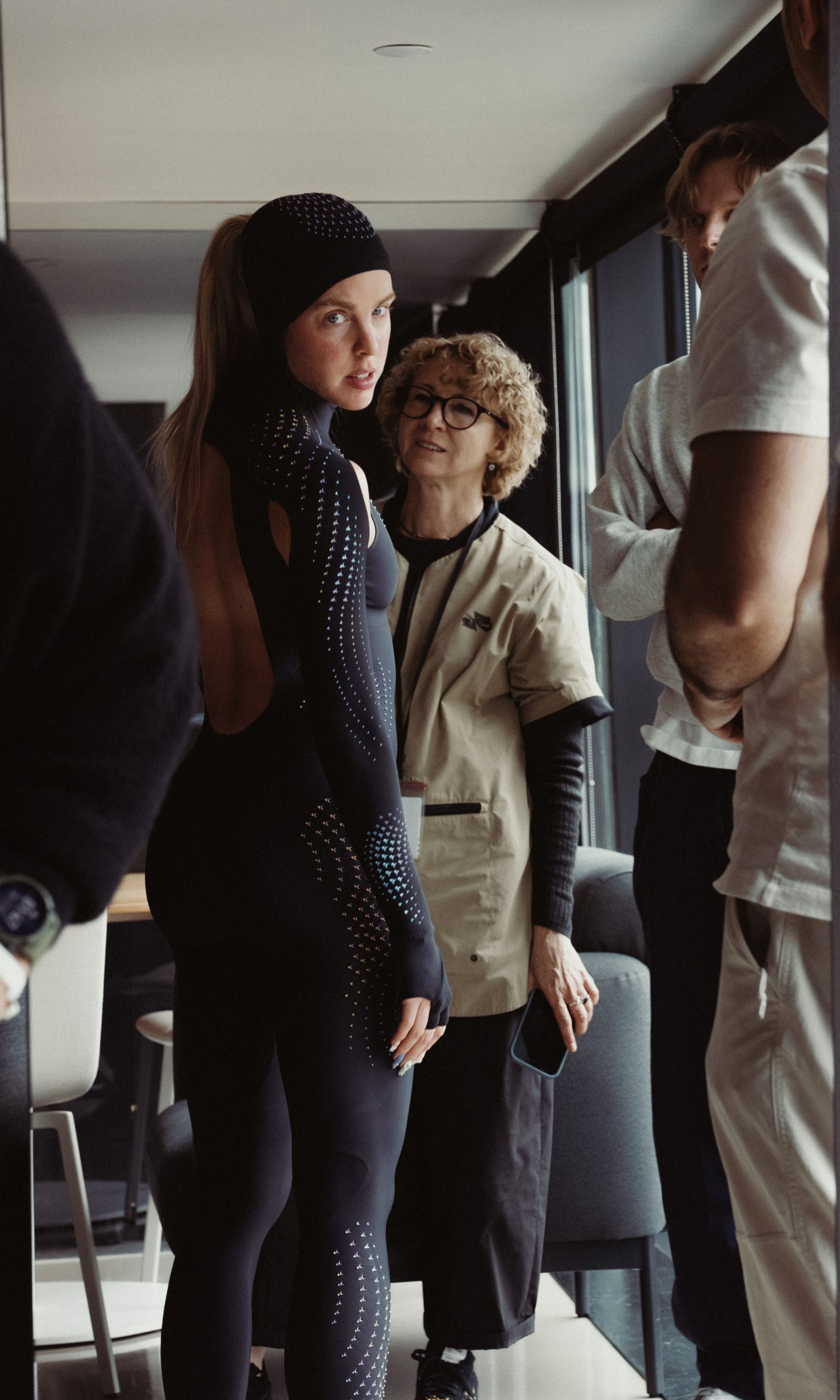 Keely Hodgkinson looks toward the camera while being fitted for a black full-body speed suit