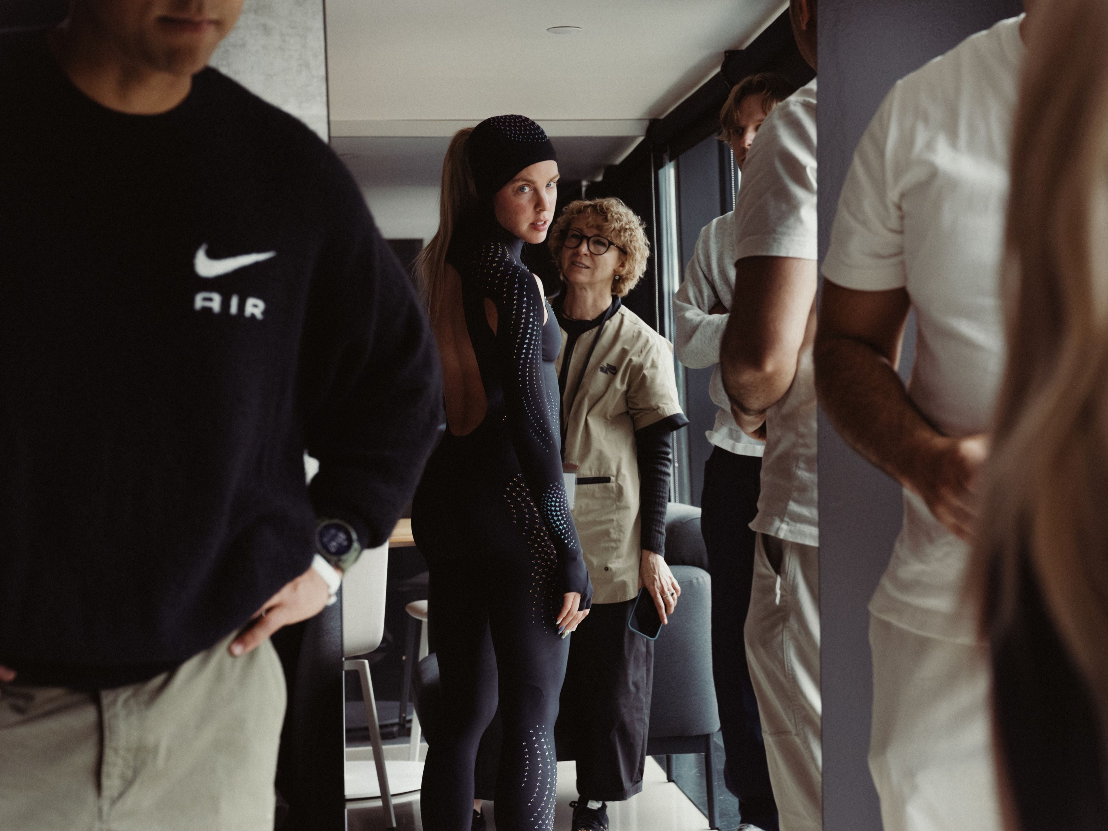Keely Hodgkinson looks toward the camera while being fitted for a black full-body speed suit