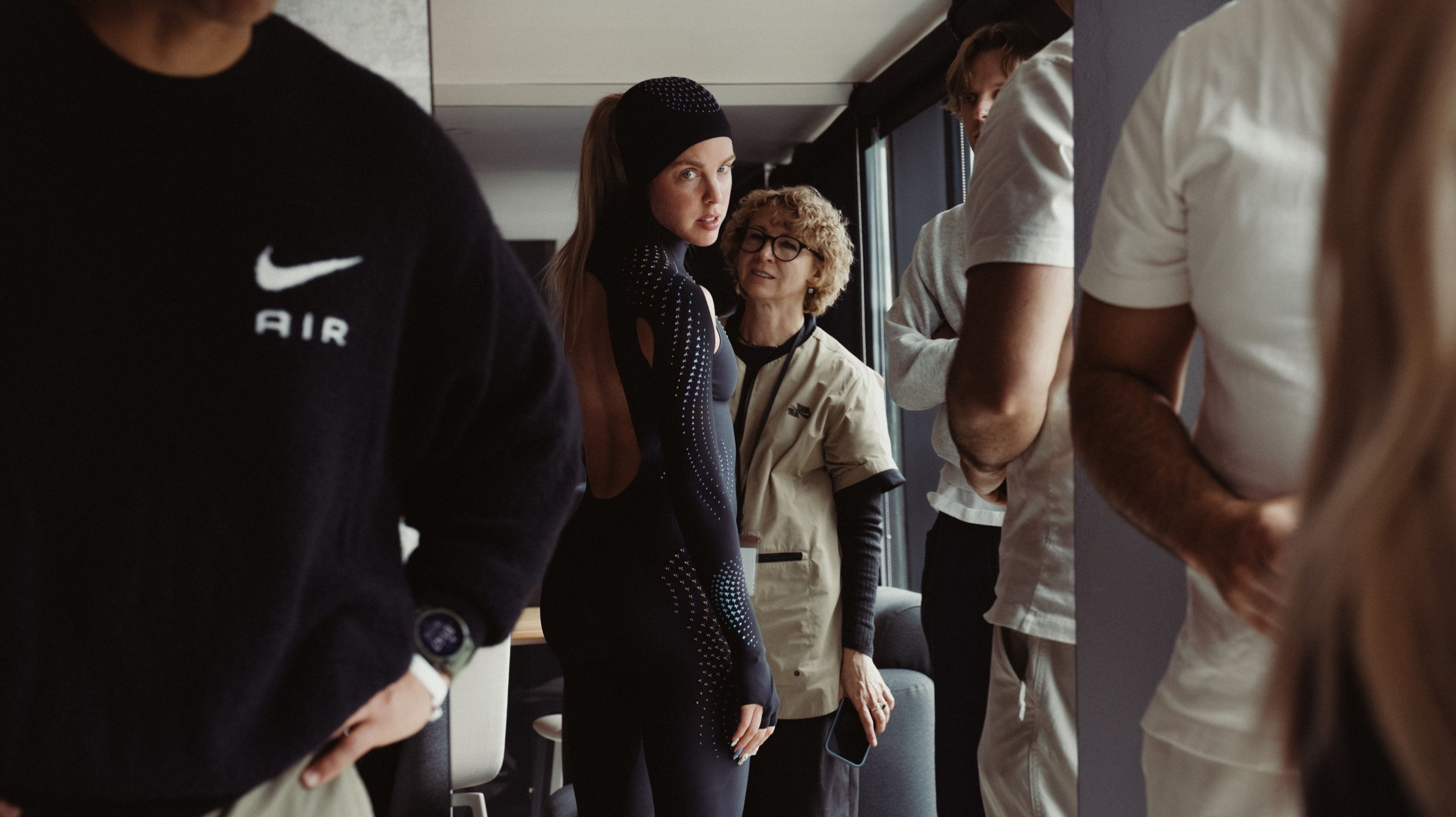 Keely Hodgkinson looks toward the camera while being fitted for a black full-body speed suit