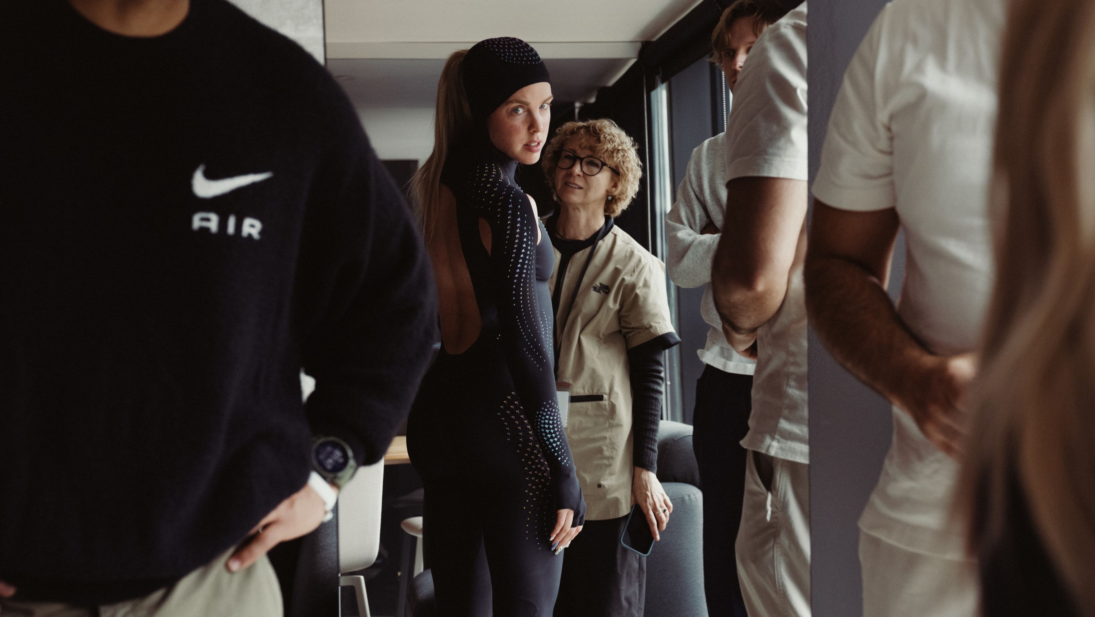 Keely Hodgkinson looks toward the camera while being fitted for a black full-body speed suit