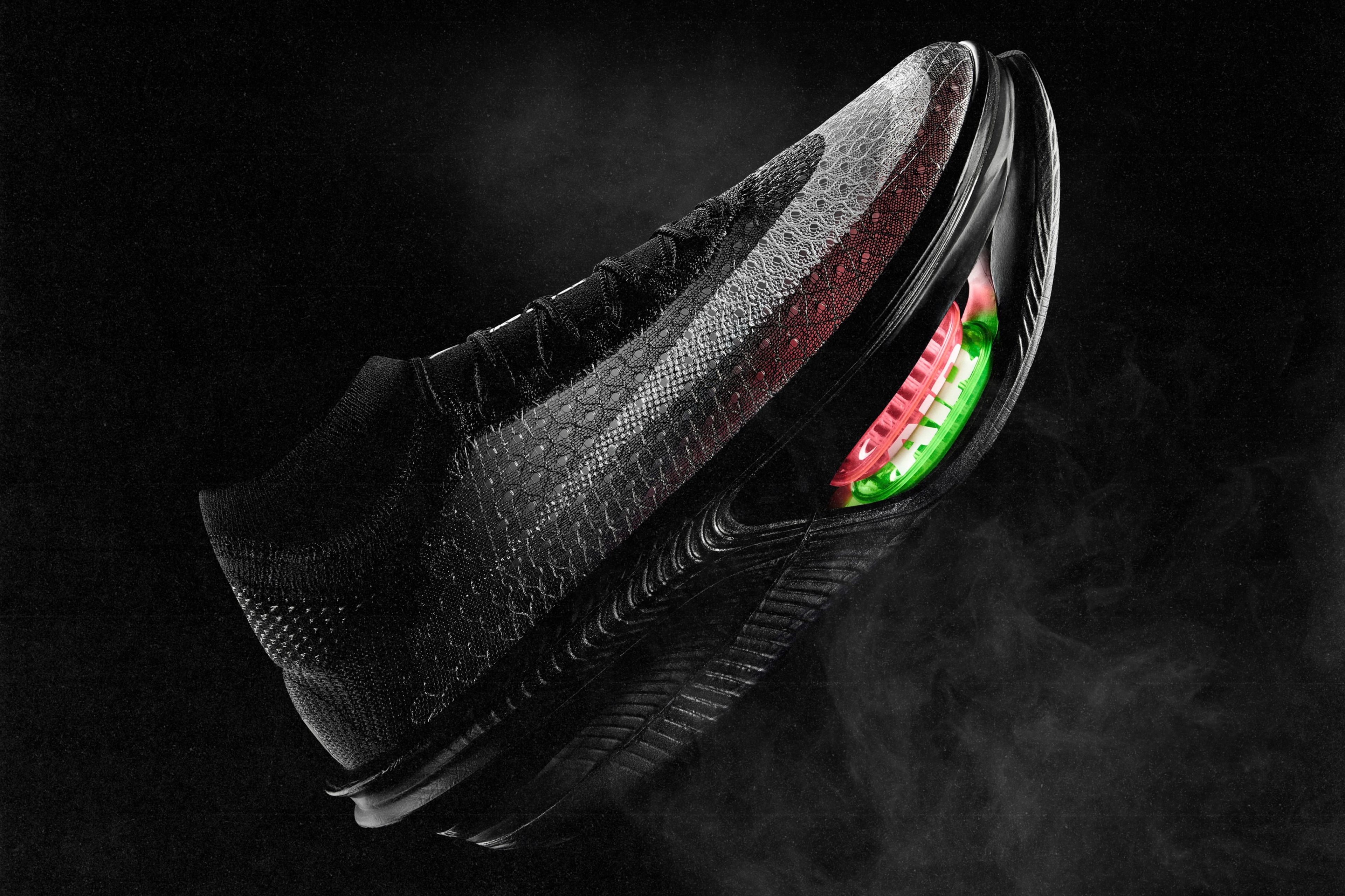 The Nike Apex racing shoe with a visible, double-stacked red and green Air Zoom unit in the forefoot, photographed against a dark background.