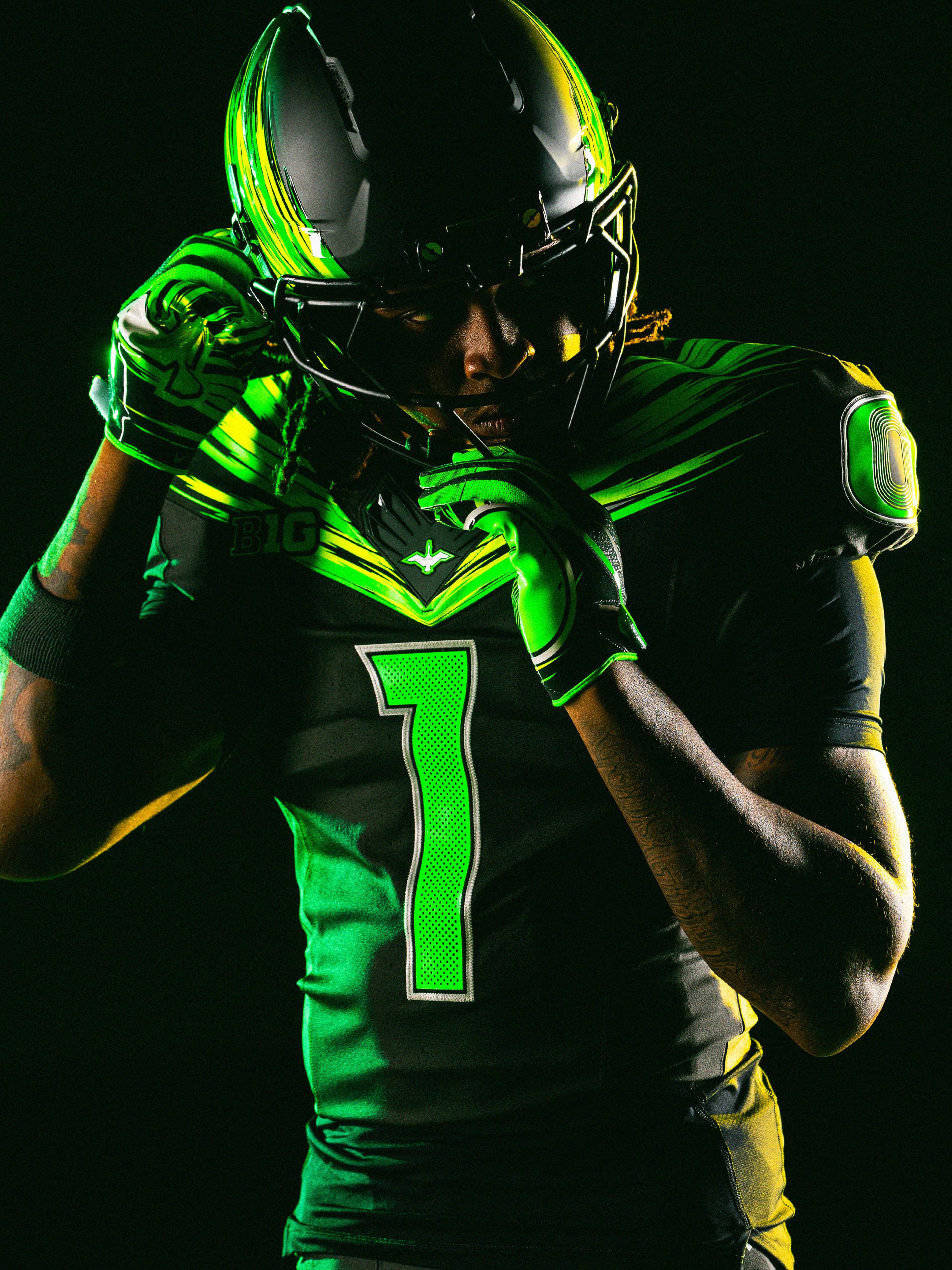 A football player wearing an Oregon Ducks uniform.