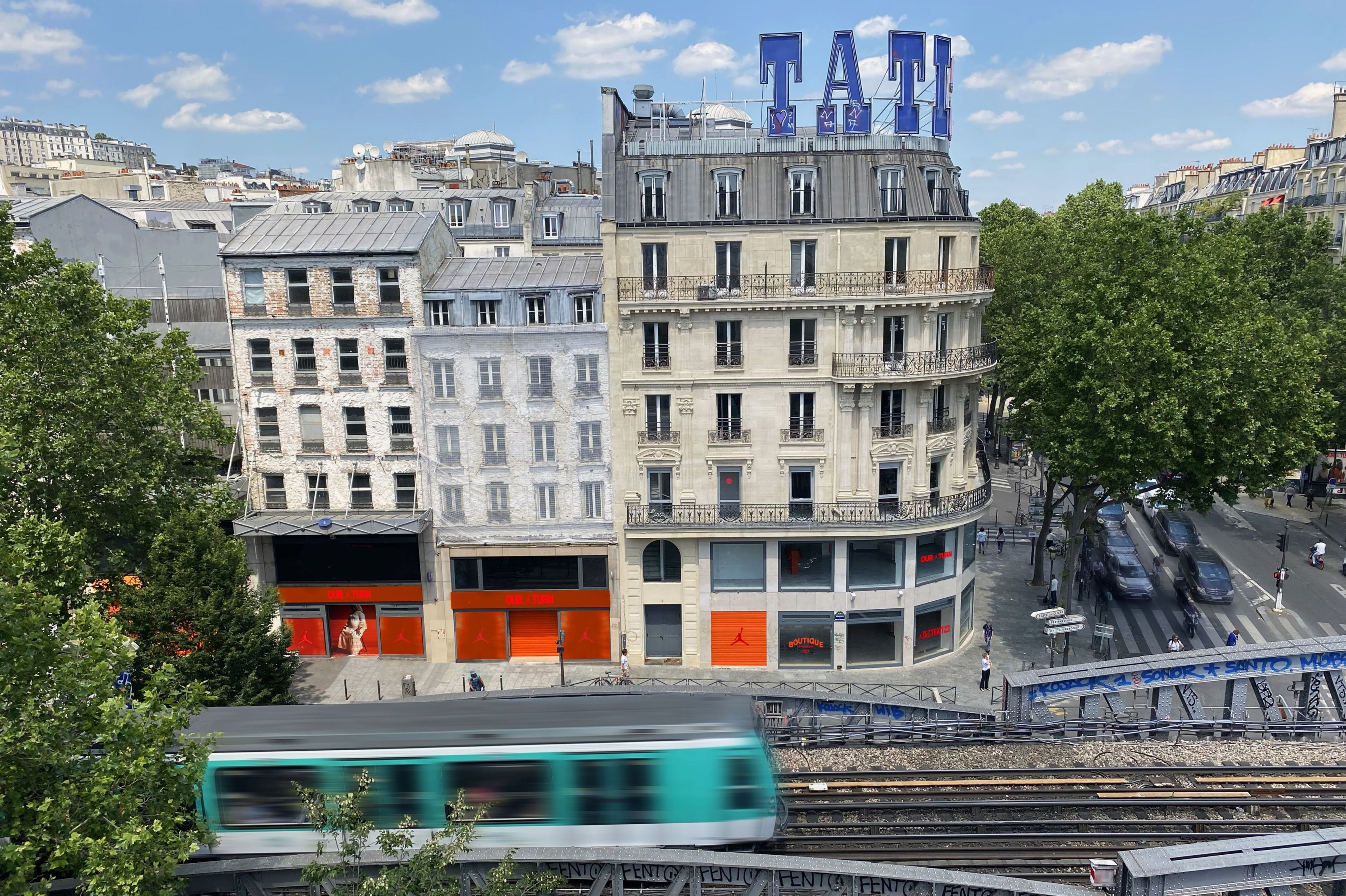 Elevated view of the Nike's District 23 gallery in Paris. The windows feature the Air Jordan logo, as well as "Our turn," "Boutique," and "District 23" in red and orange color schemes.