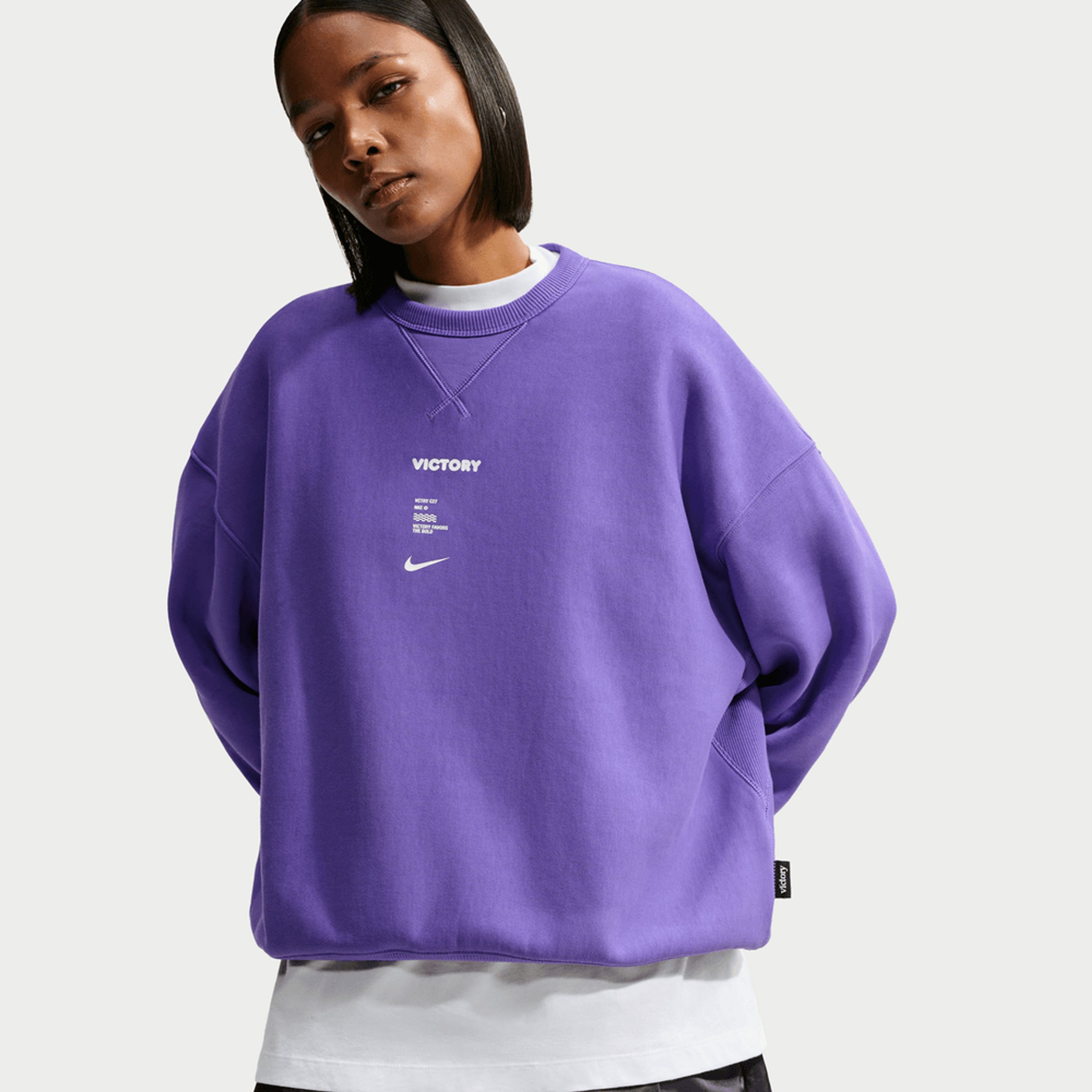 Woman wearing an oversized purple Nike Victory Collection crewneck