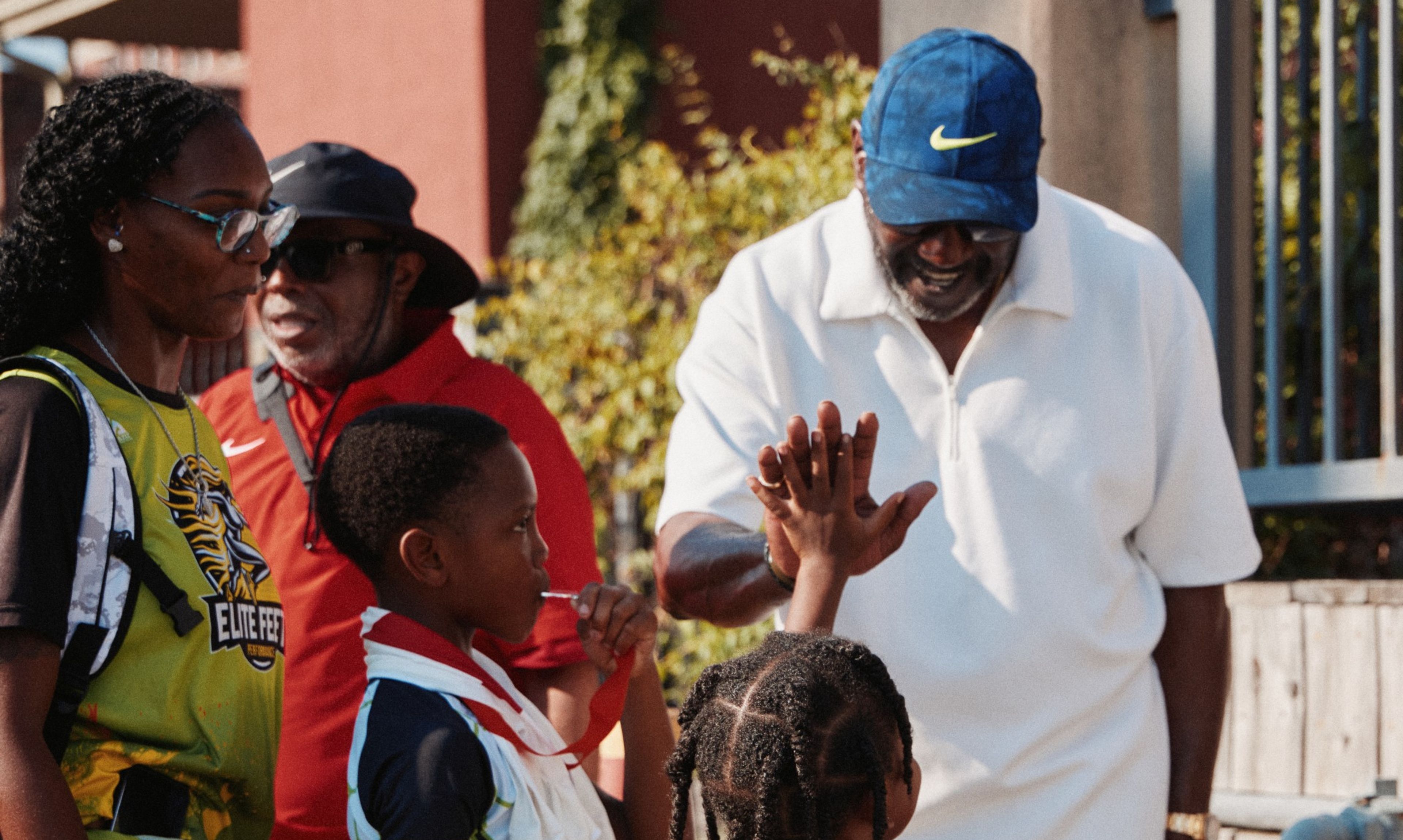 Willie Gregory high-fives a kid at the Nike Kids 3K in Memphis.