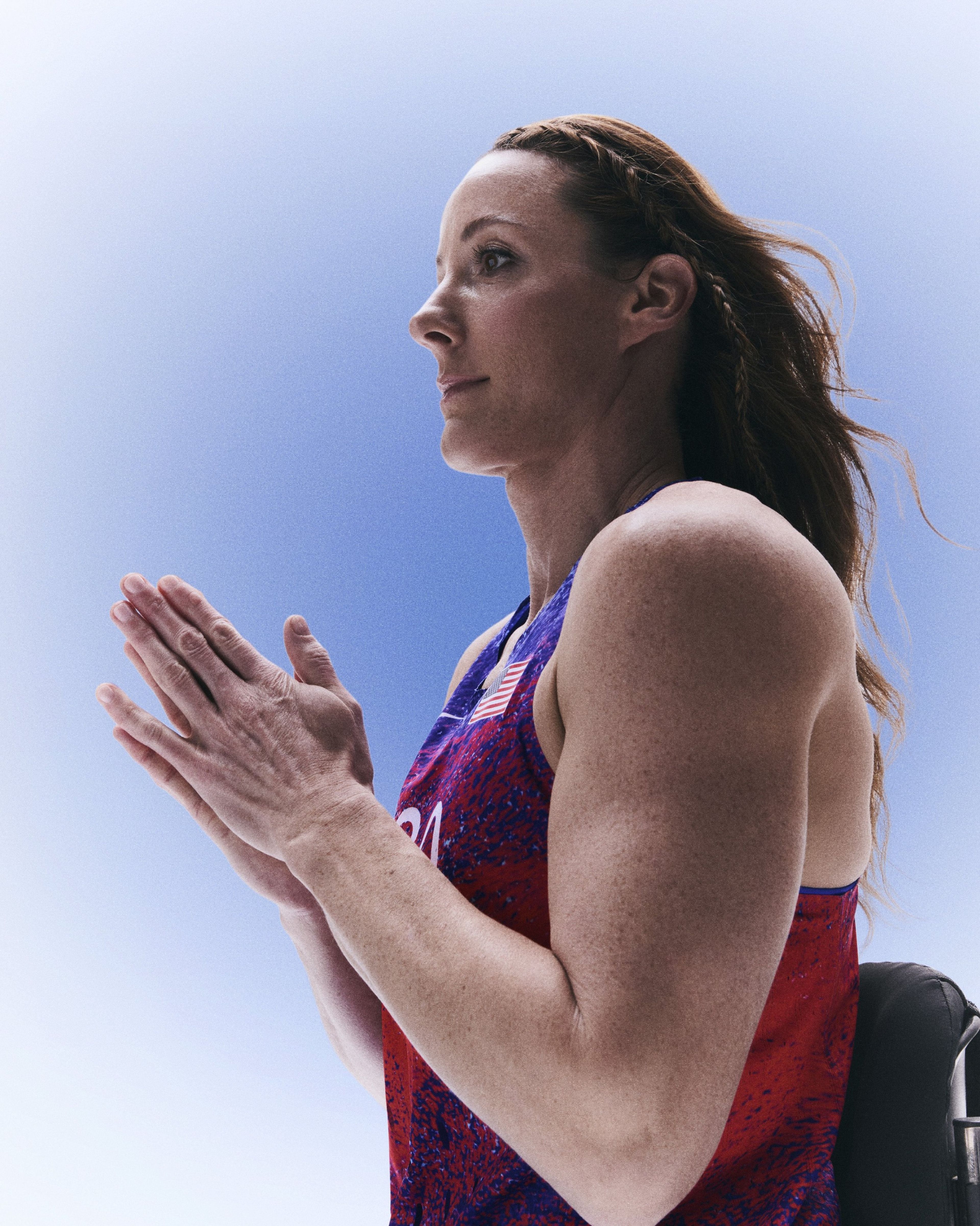 Tatyana McFadden clapping her hands together while wearing her USA track and field kit uniform.