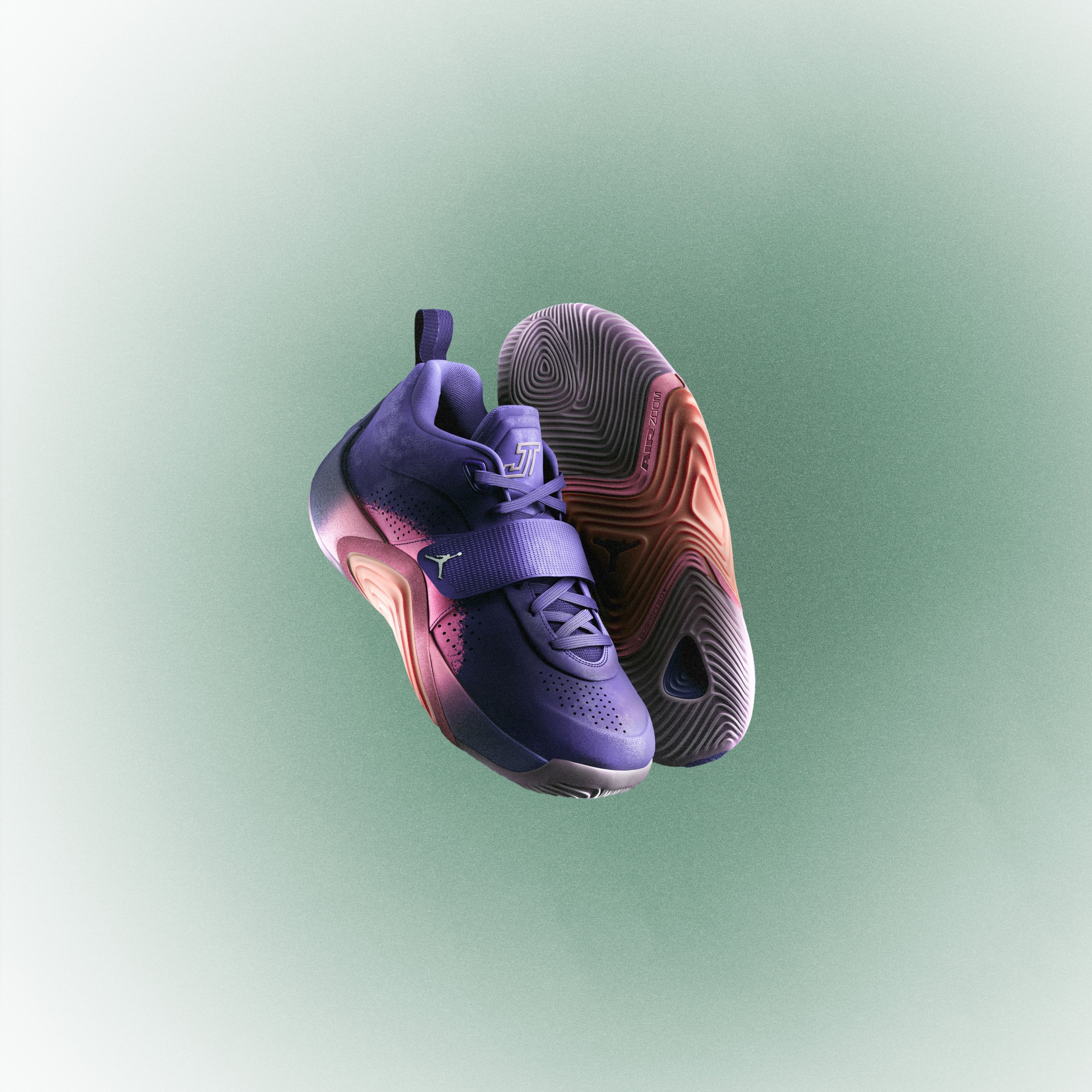 The kids model of the Jordan Brand Tatum 5 is pictured in the Sunrise colorway in front of a green and white background.