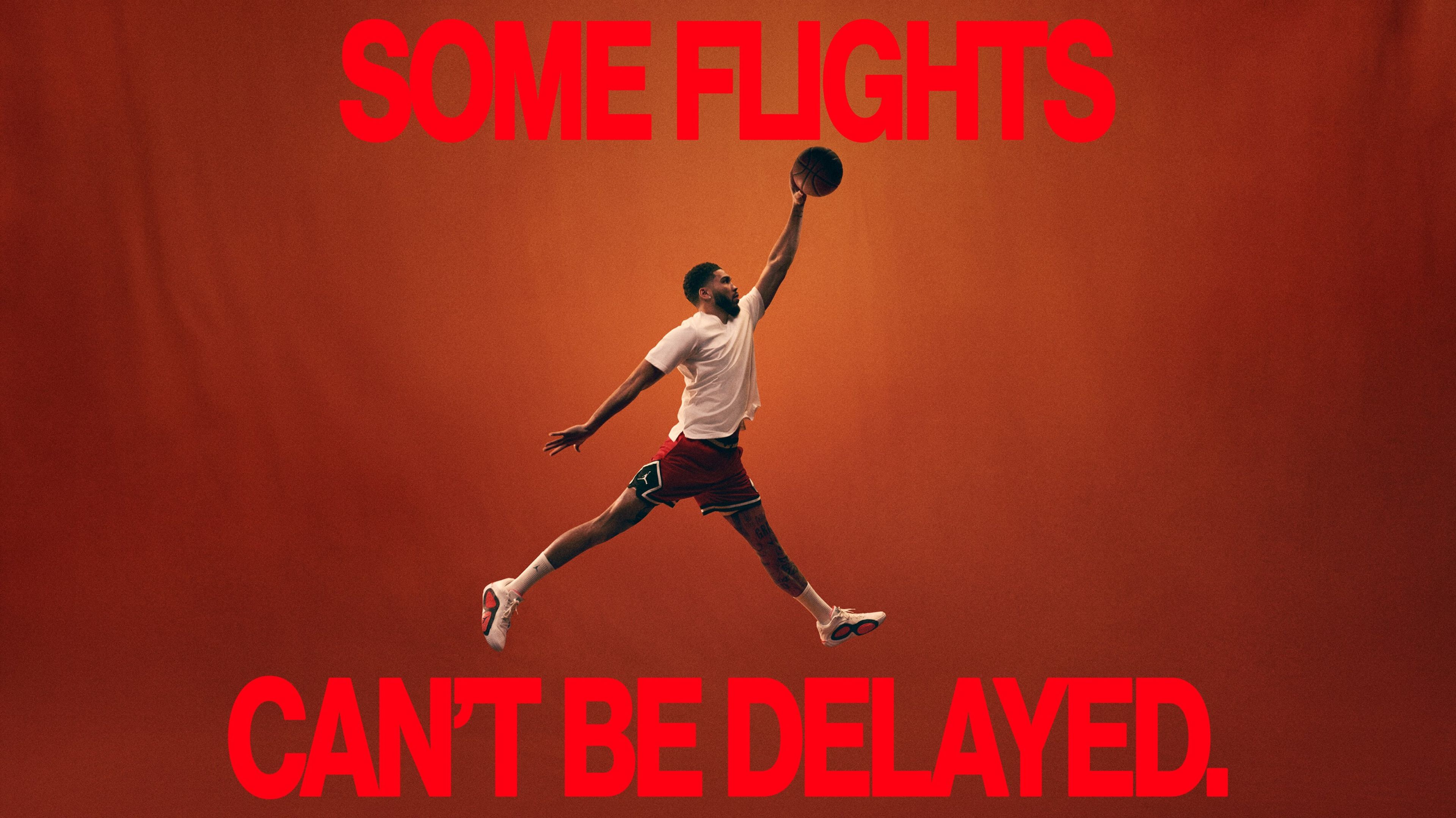 A basketball athlete strikes the Air Jordan dunk pose on an orange background. A caption in red font reads, "Some flights can't be delayed."