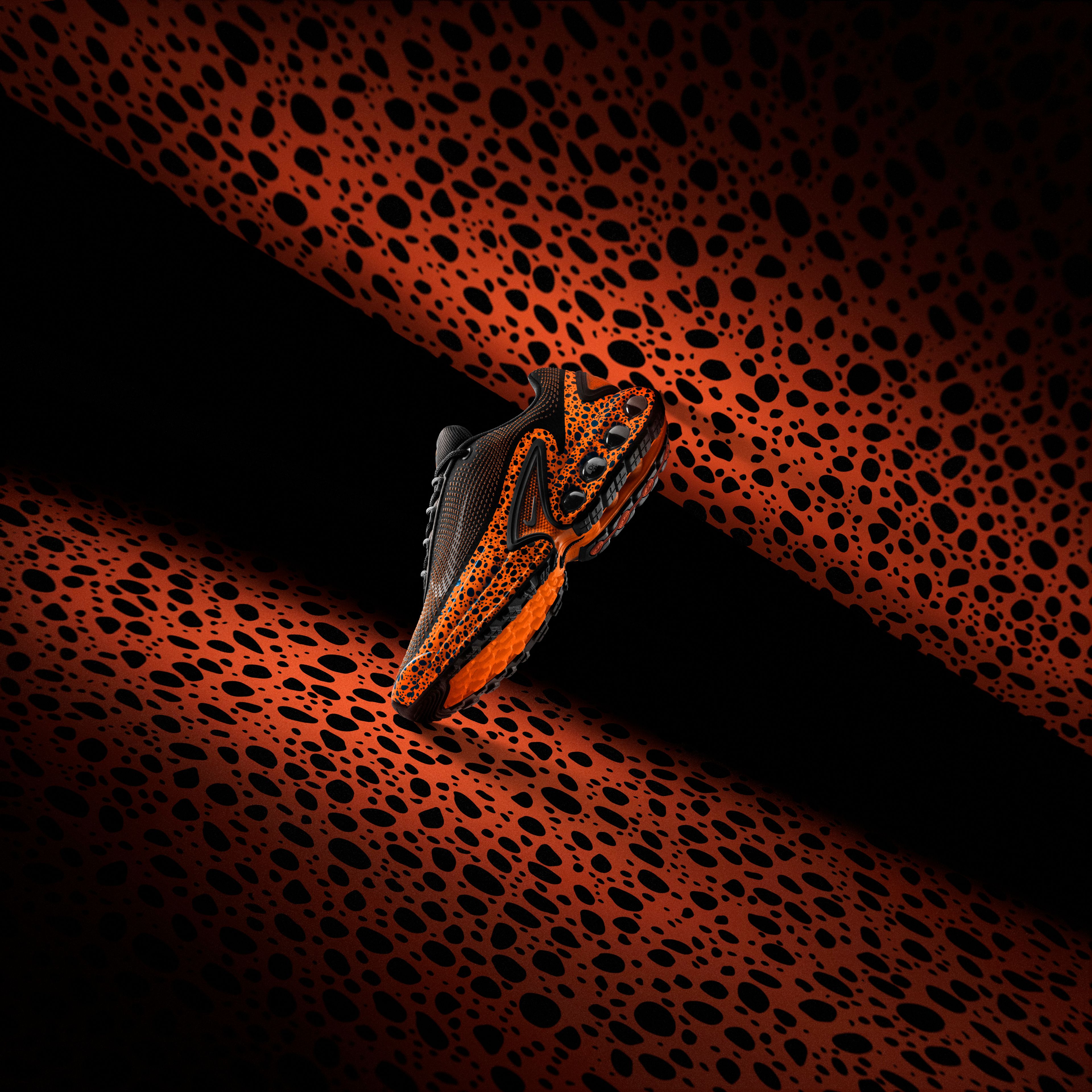 Left view of the Nike Air Max Dn in electric pack color way that combines ostrich print and total orange