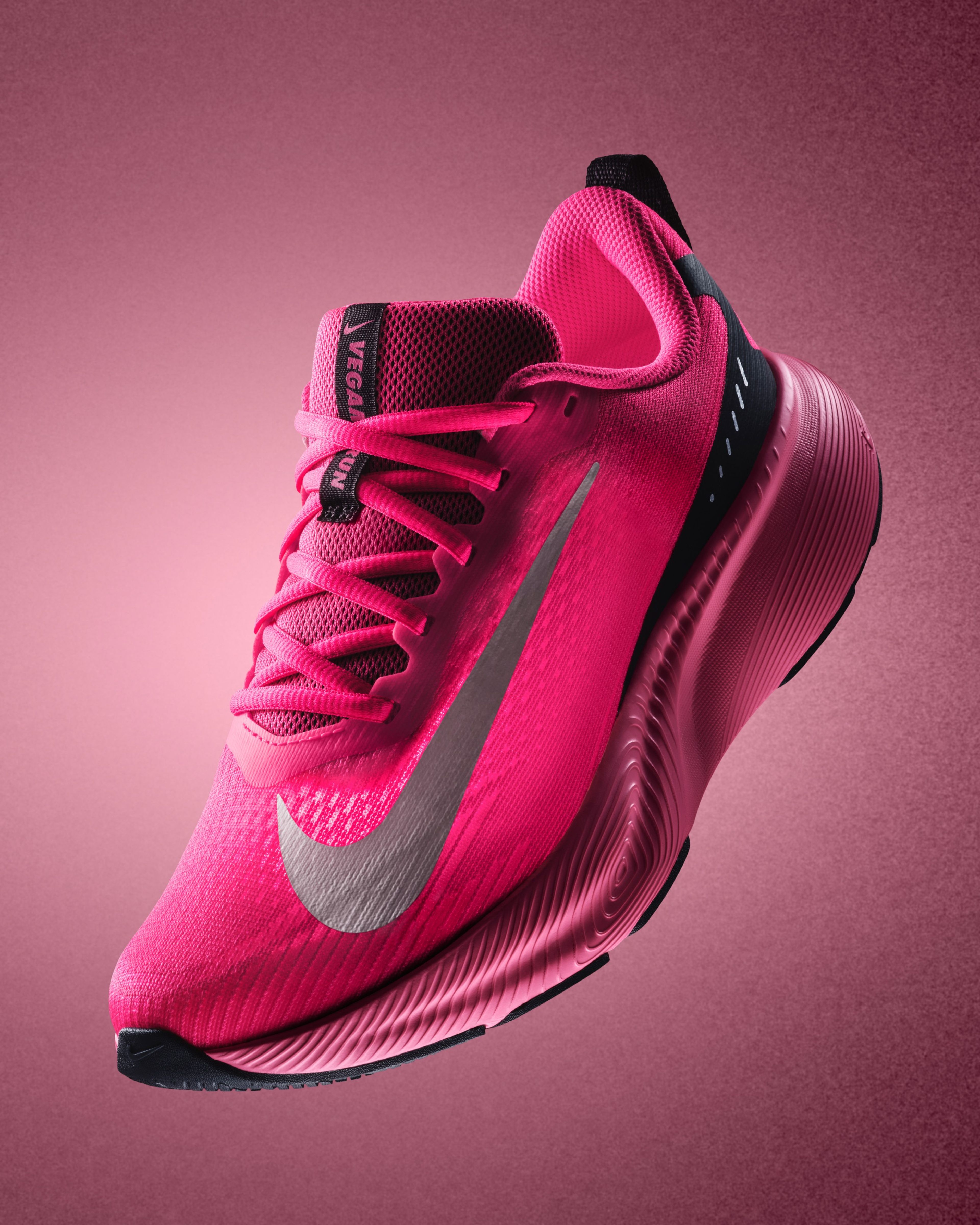 A bright pink Nike Vegam Run shoe