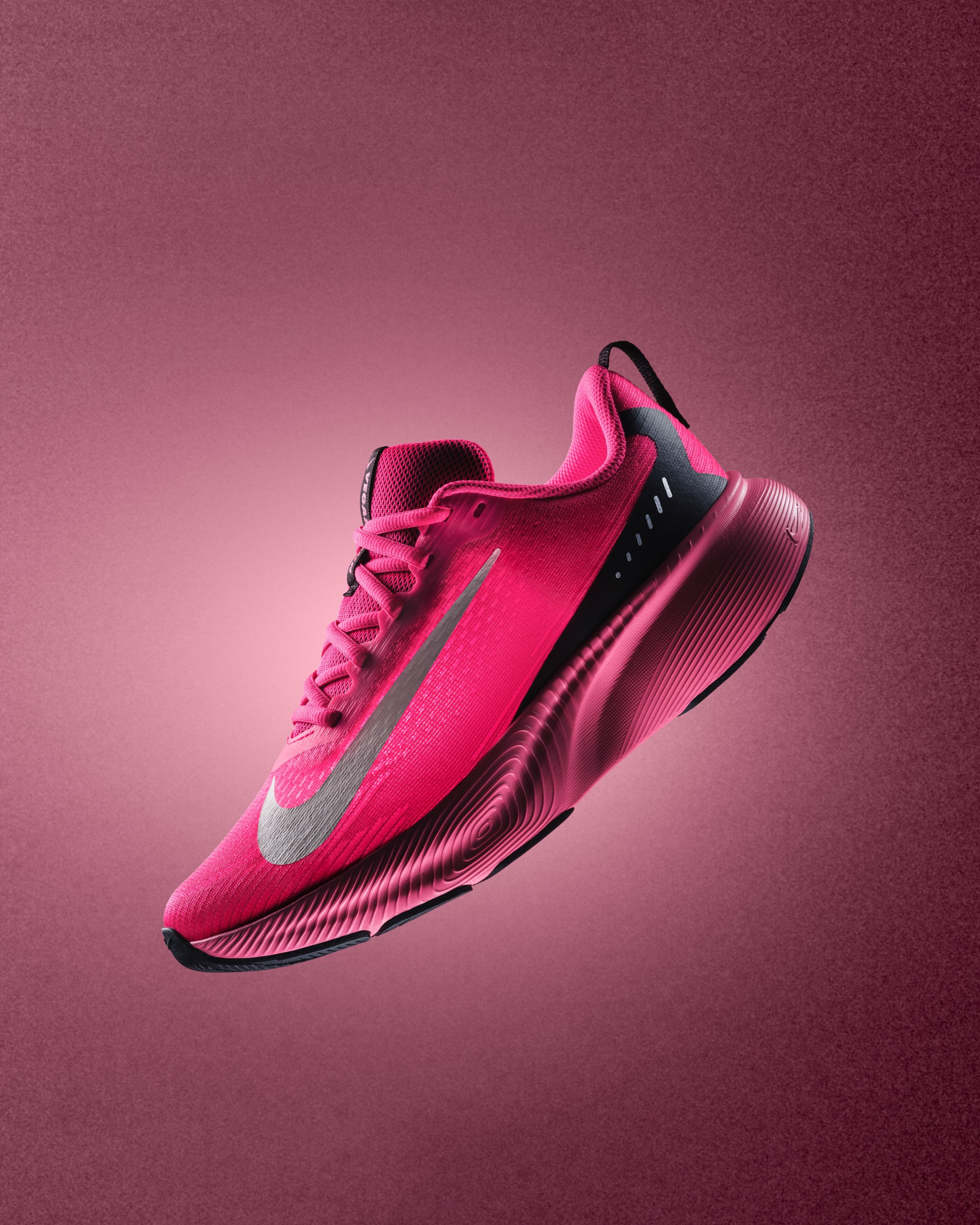 A bright pink Nike Vegam Run shoe