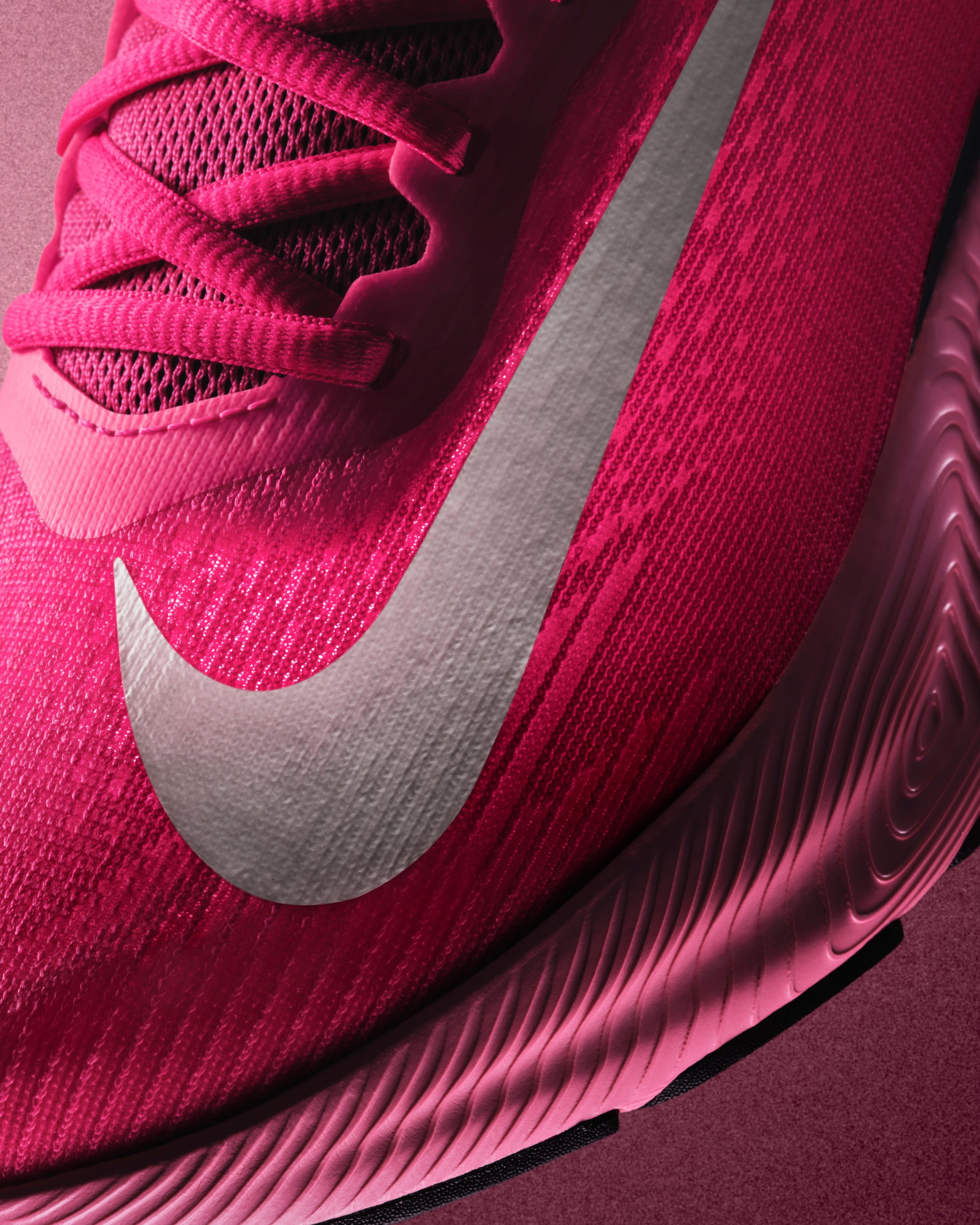 A bright pink Nike Vegam Run shoe