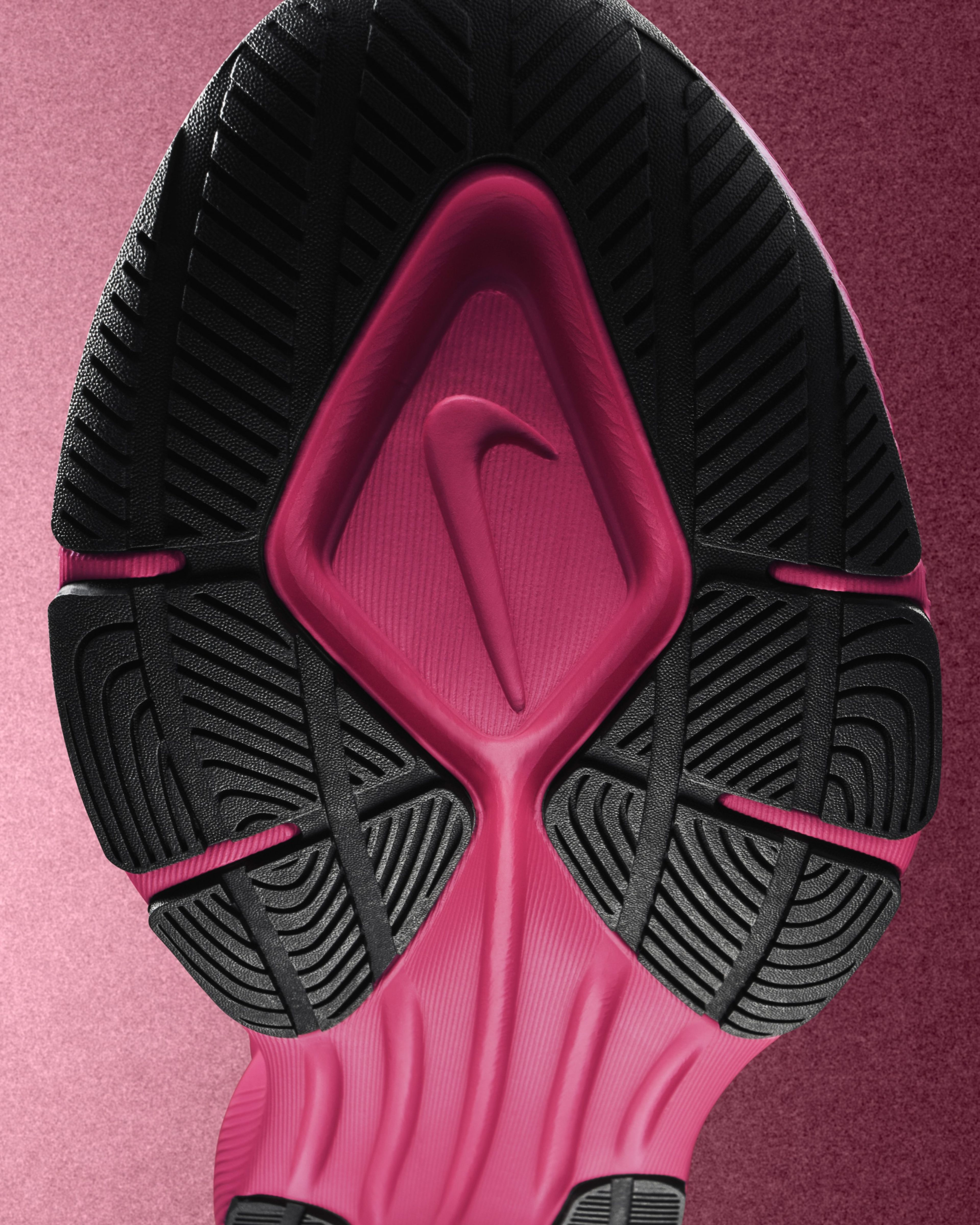 Close-up of the sole of a bright pink Nike Vegam Run shoe