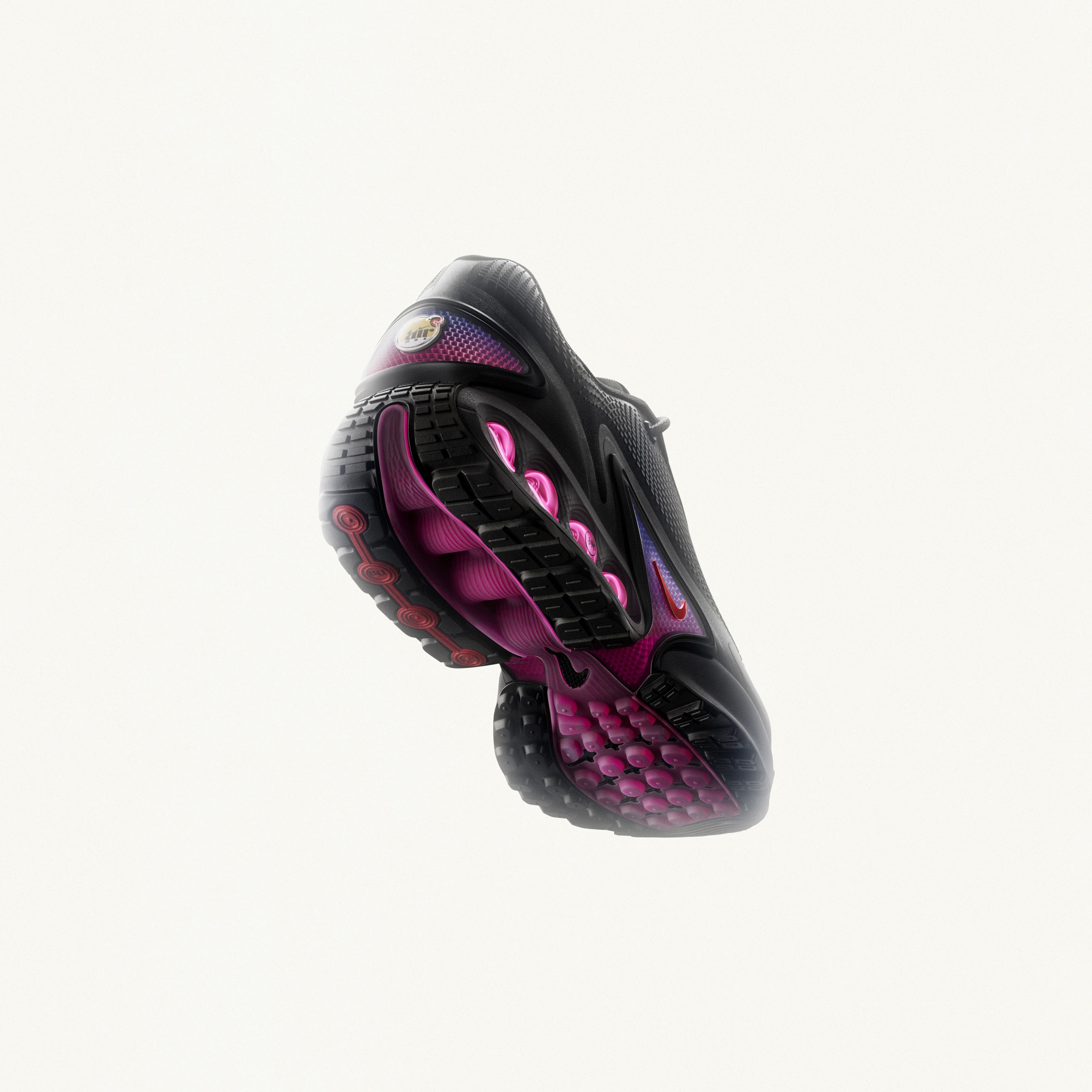Rear view of the men's Nike Air Max Dn in black and pink