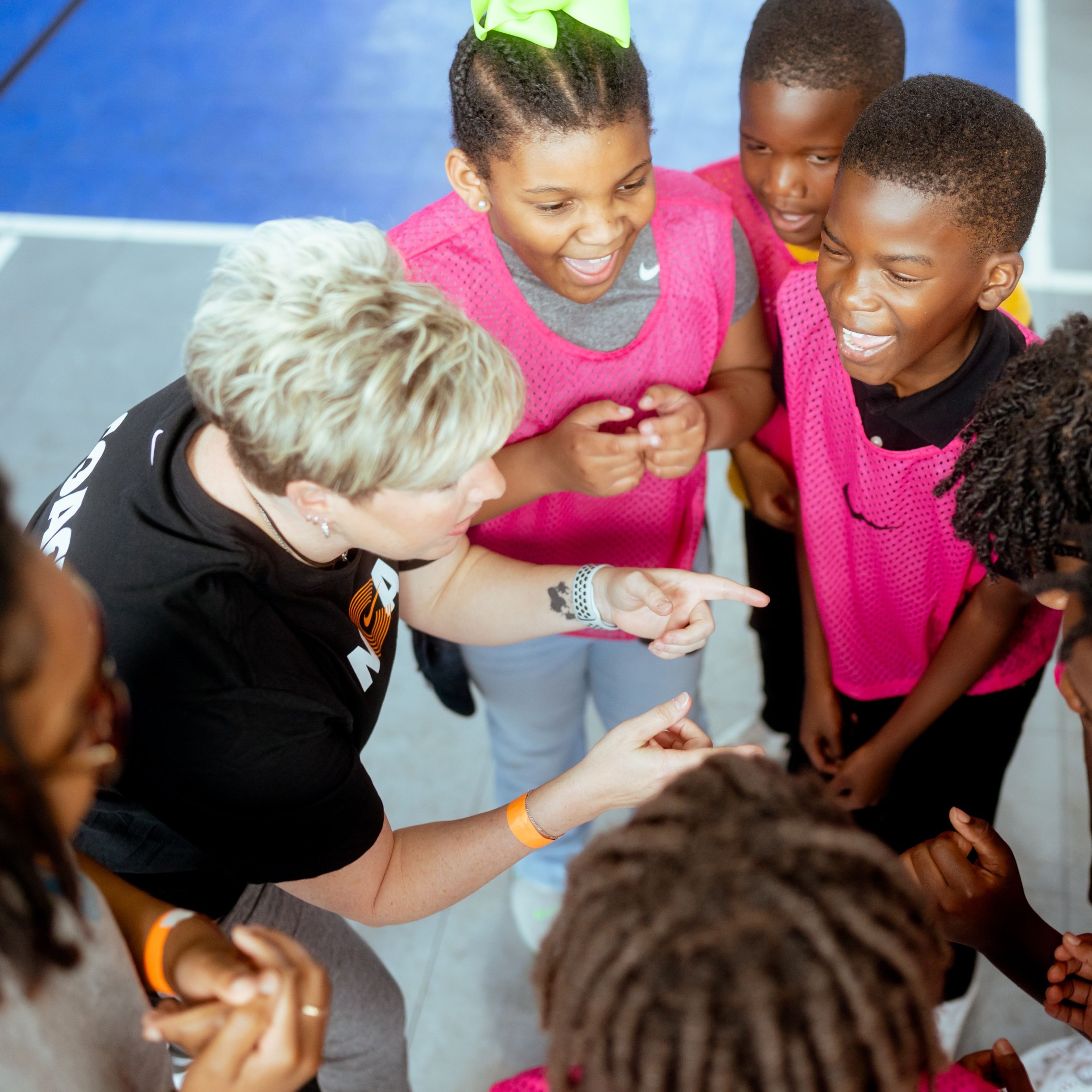 A Nike NCA teammate is pictured coaching a group of youth.