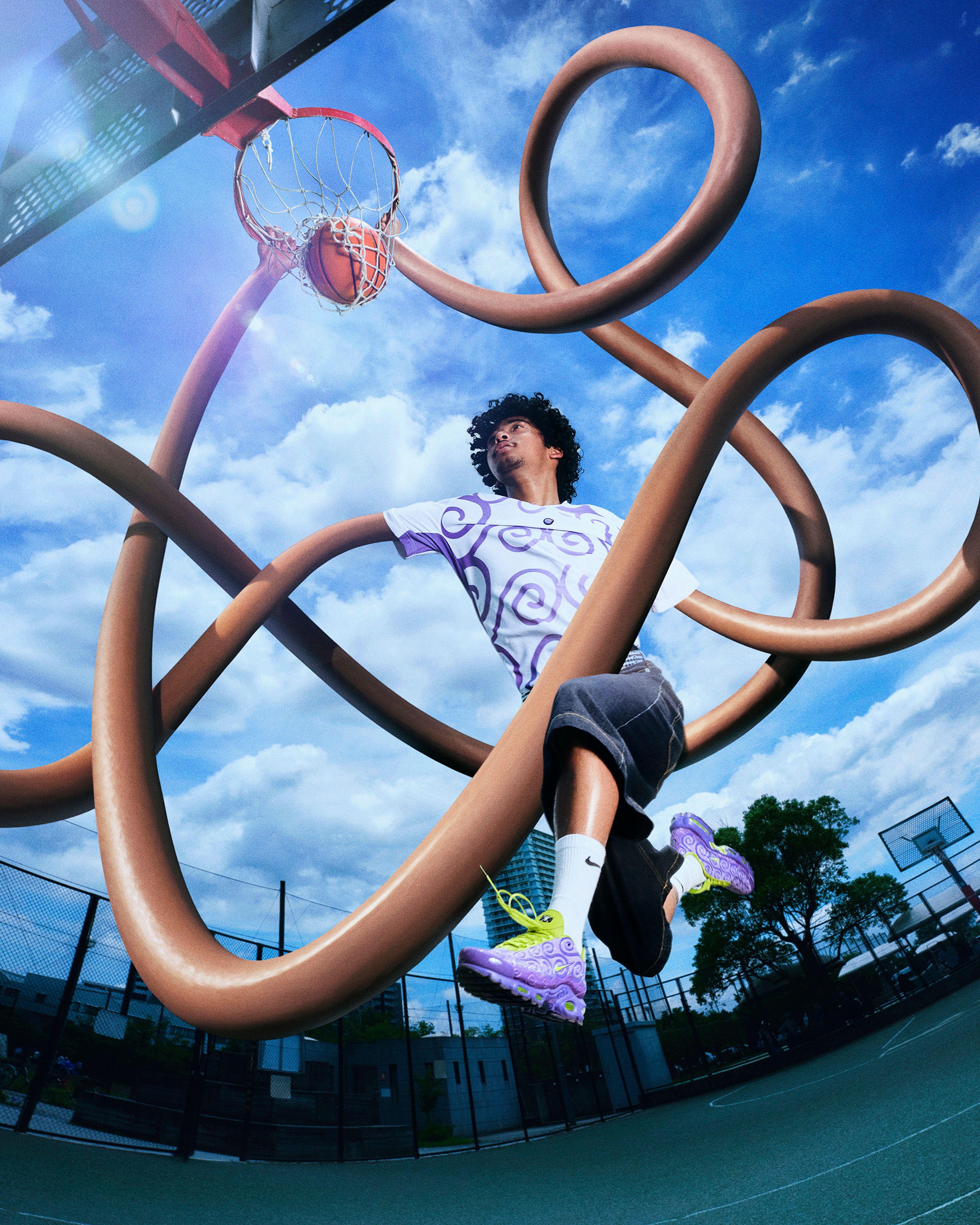 A basketball player with curly hair wearing purple and white patterned sneakers and shirt leaps toward a hoop on an outdoor court, surrounded by surreal looping brown tubes.