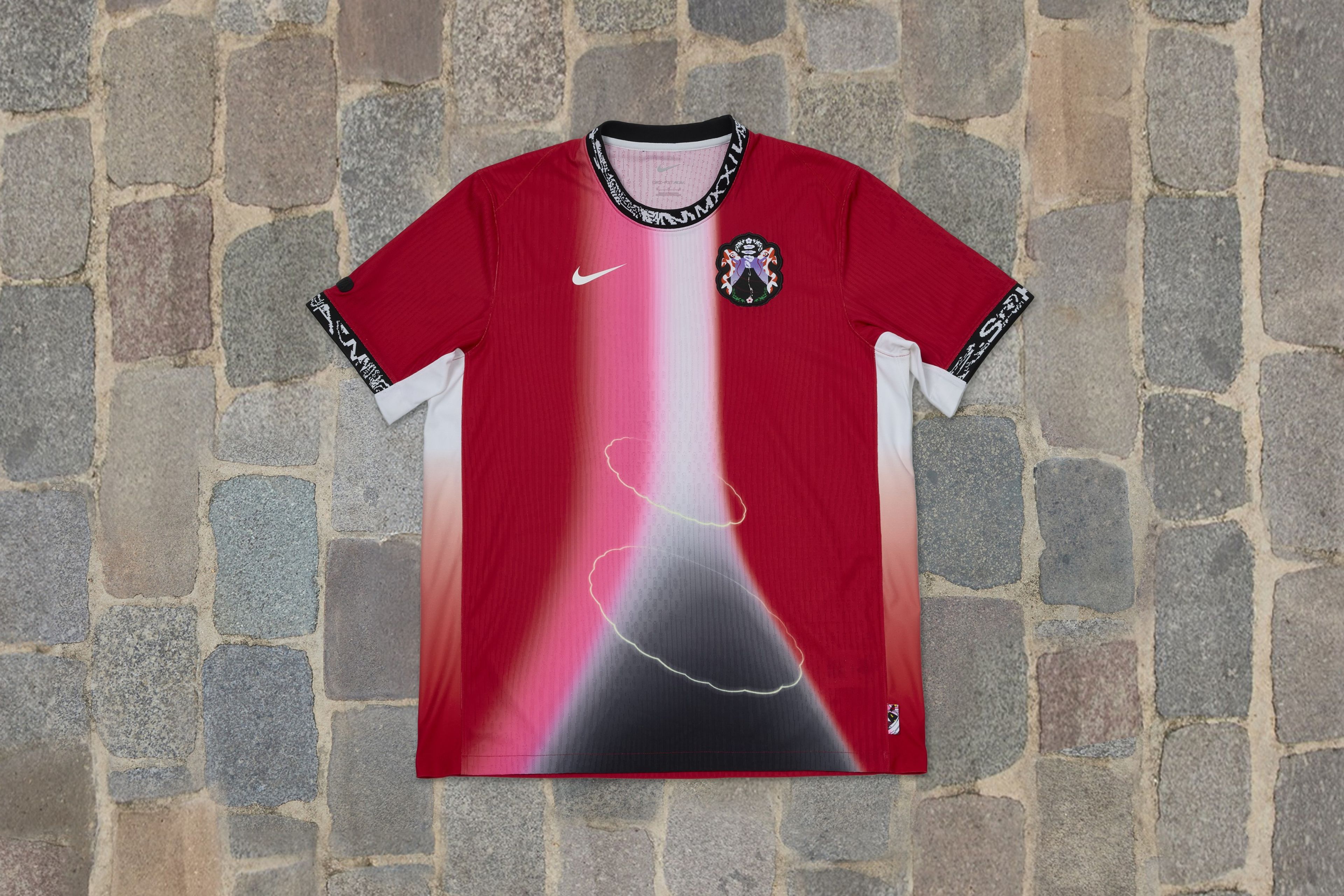 Overhead view of a shirt in cherry blossom colors that's part of Japan's skateboarding federation kit