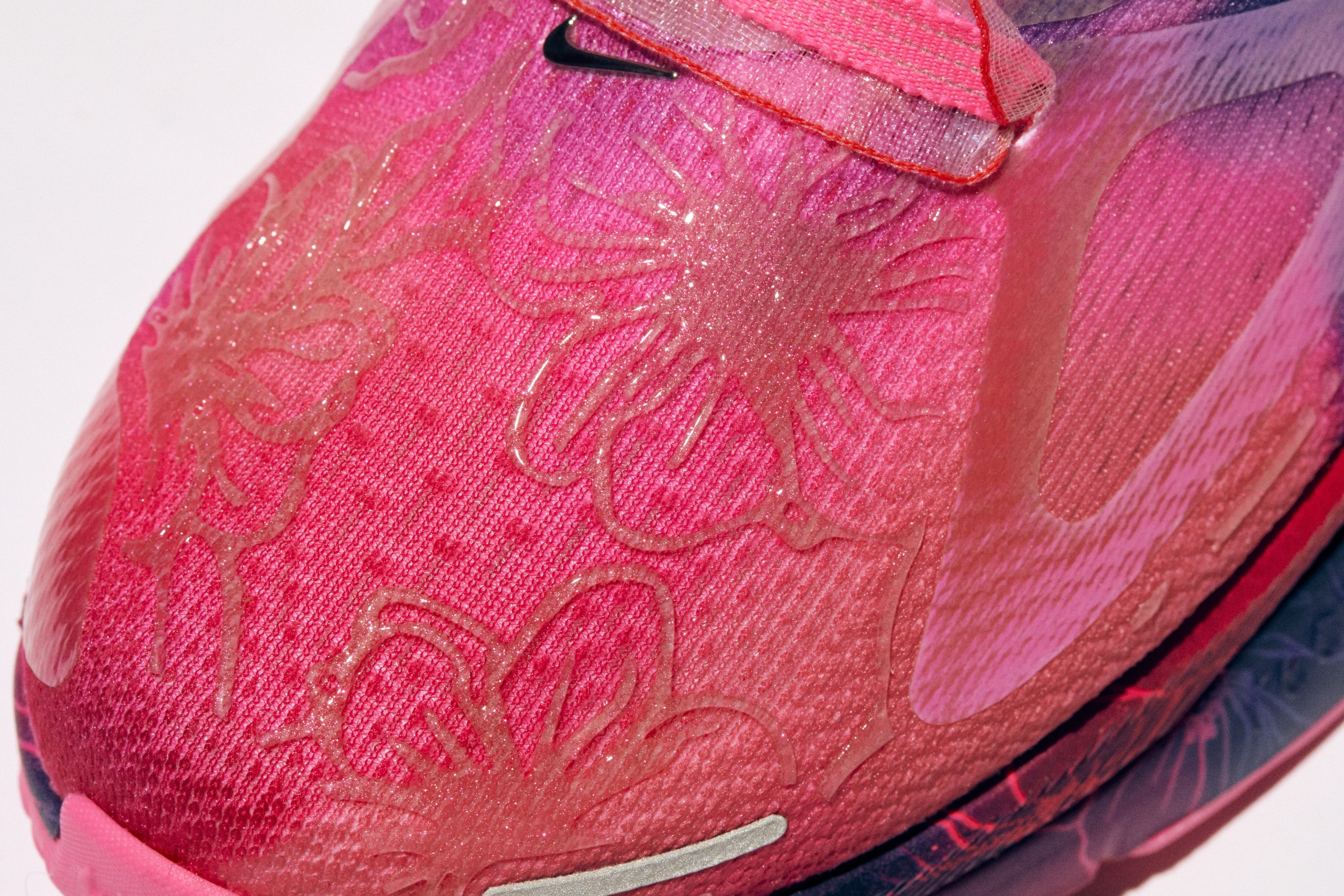 The Nike Structure Plus upper displays cherry blossom flowers.