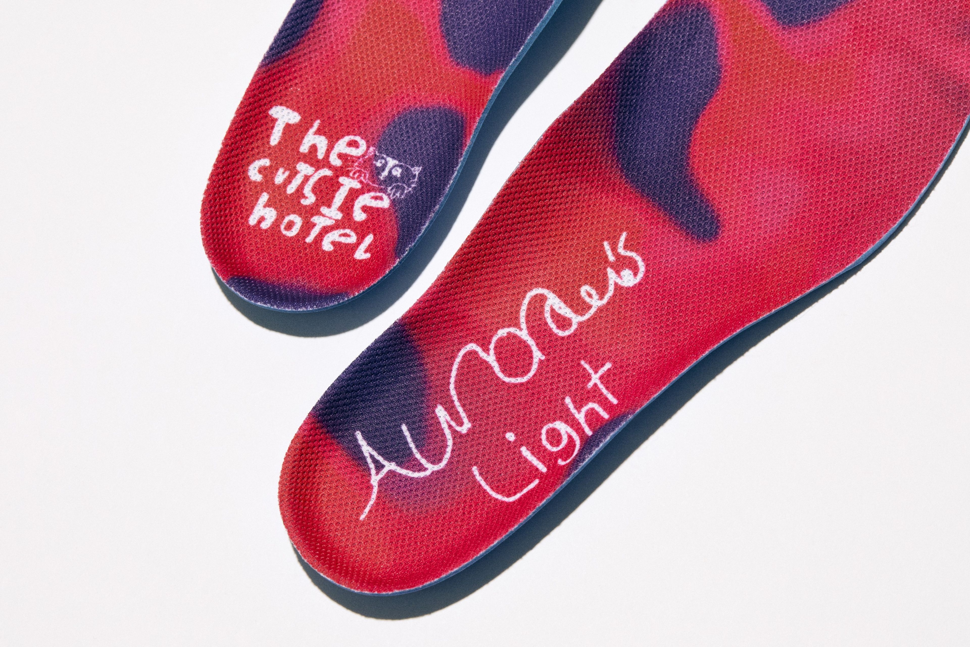 The left sock liner features a “cutsie hotel” logo; the right insole shows “Aurora’s Light."