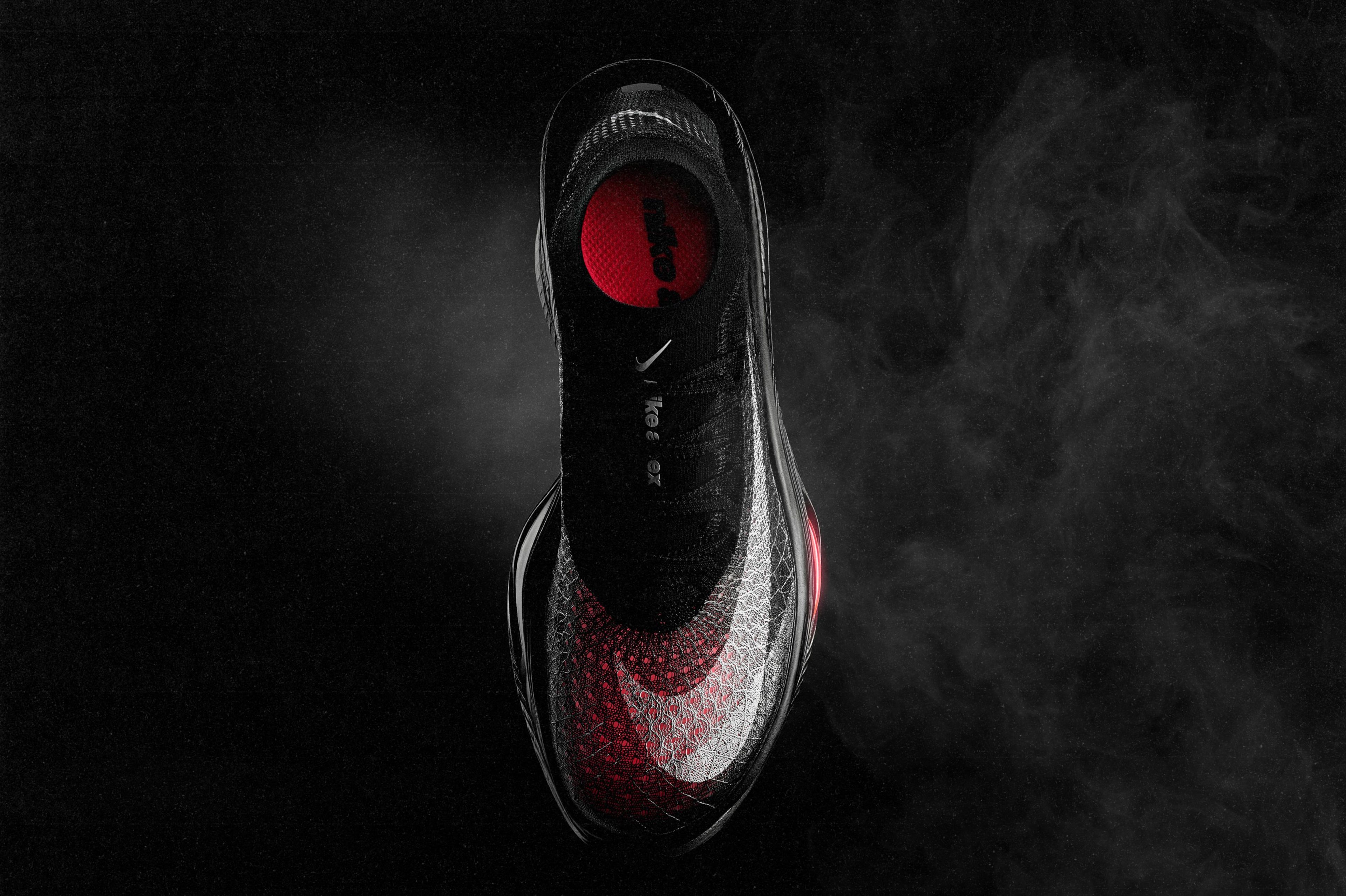 Top-down view of the Nike Apex racing shoe against a dark background.