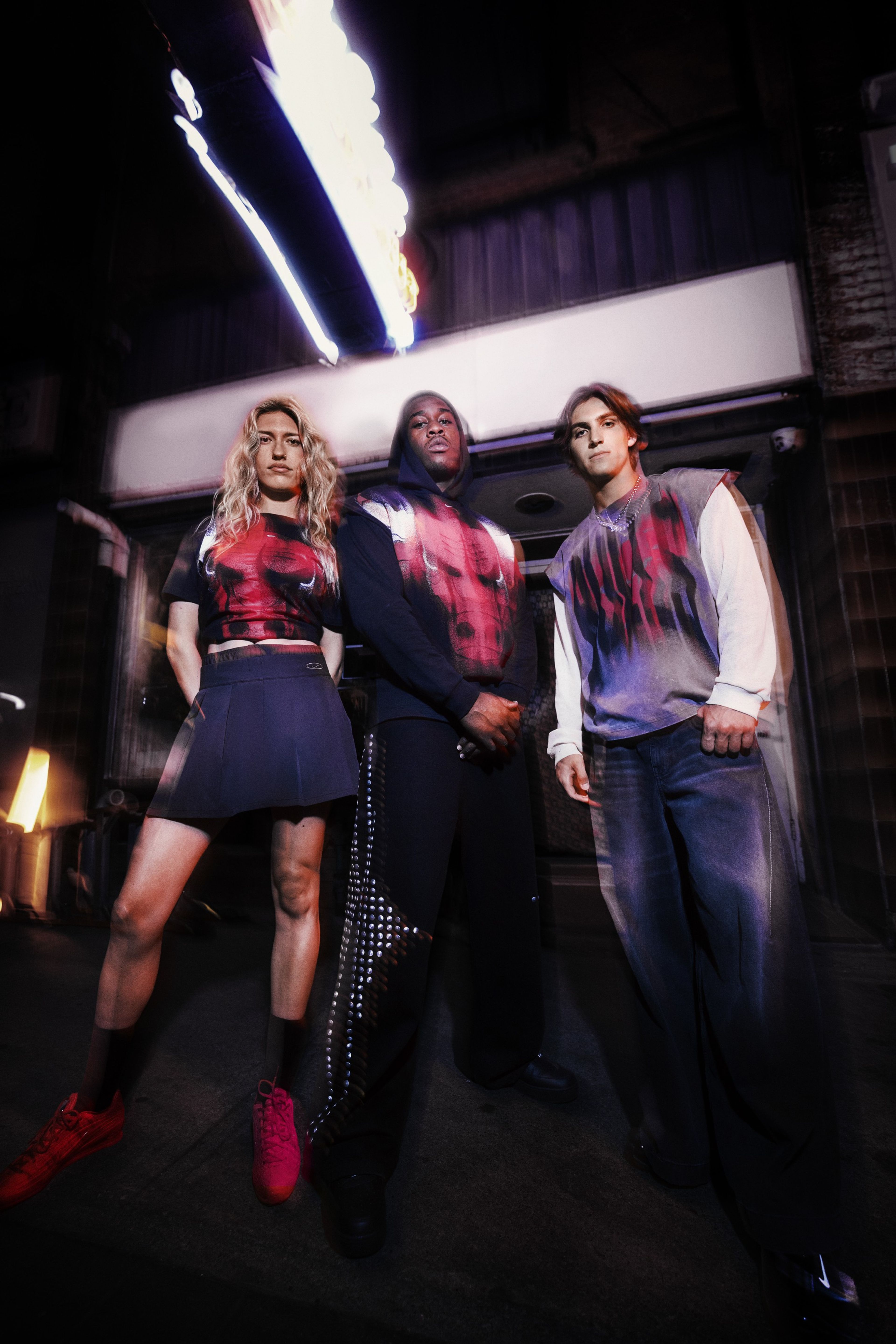 Three people pose for a blurry photo while wearing Chicago Bulls pieces from Nike’s NBA Standard Issue Collection.