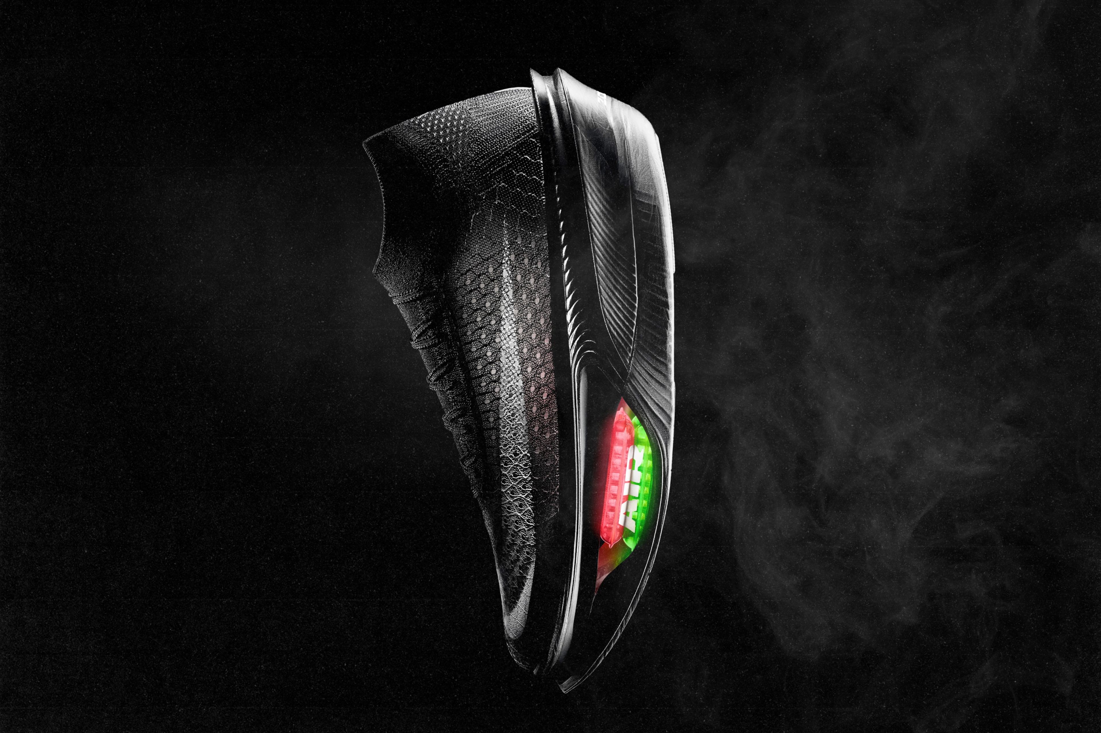 The Nike Apex racing shoe with a visible, double-stacked red and green Air Zoom unit in the forefoot, photographed against a dark background.