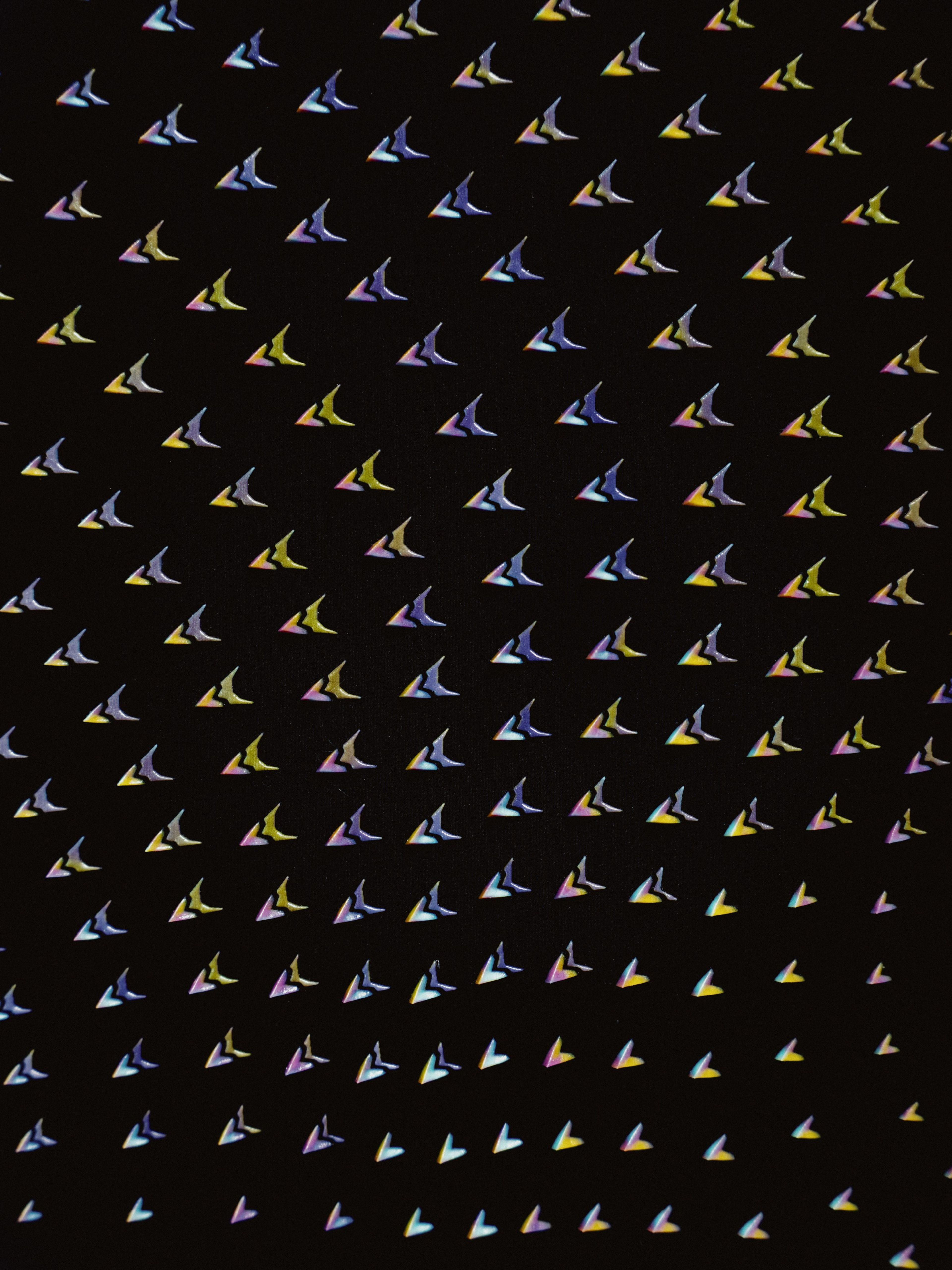 A close-up look at Nike’s fastest vortex generators: 3D-printed, color-shifting delta shapes computationally arrayed along the shoulders, thighs, torso and hood of Keely Hodgkinson's speed suit.
