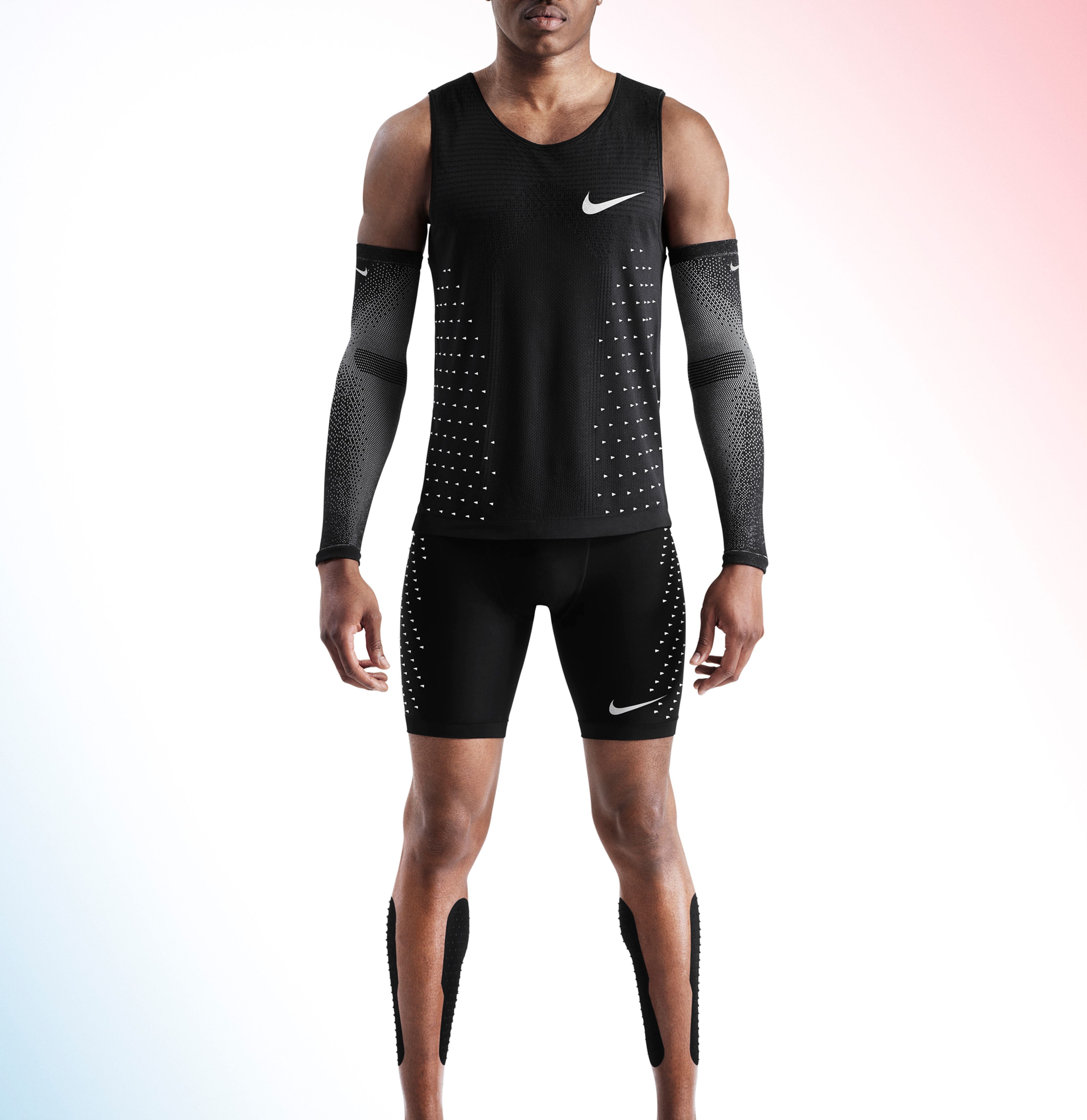 A man is photographed in a Nike tank top, shorts and arm sleeves.