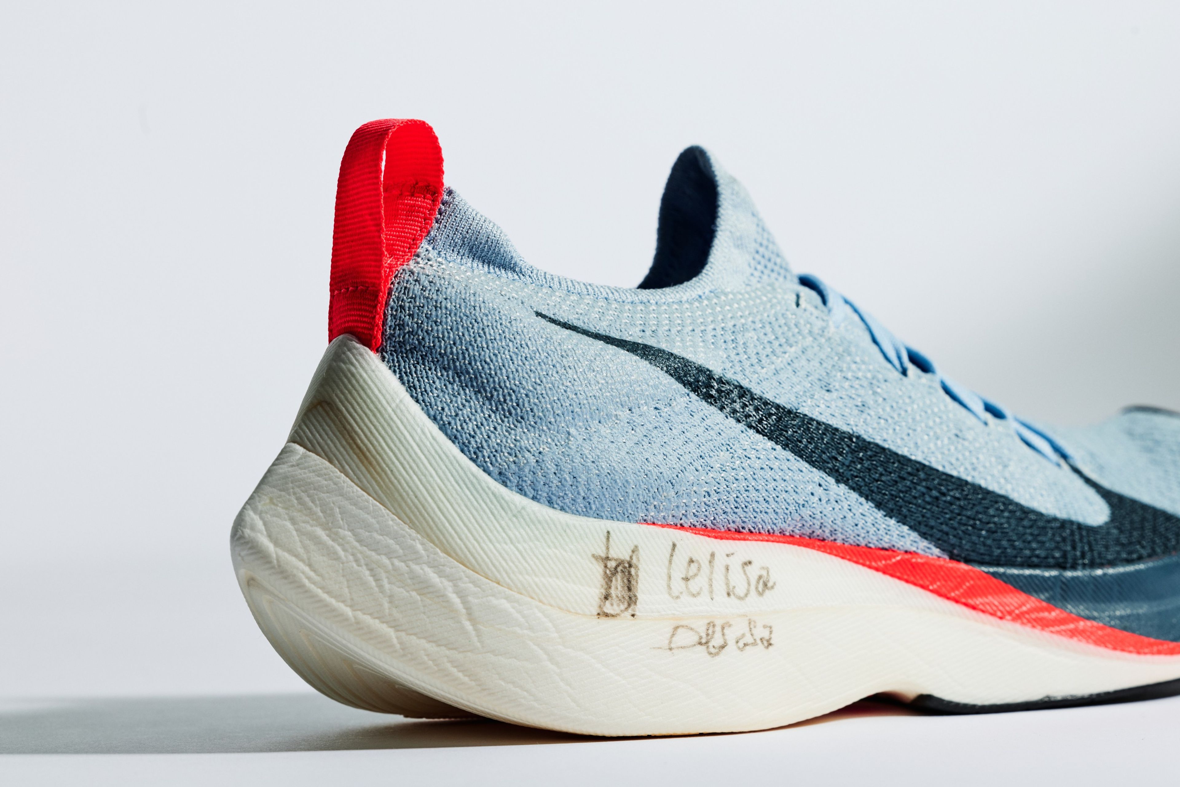 Nike Zoom Air Vaporfly Elite in light blue with Lelisa Desisa's signature on the white ZoomX midsole.