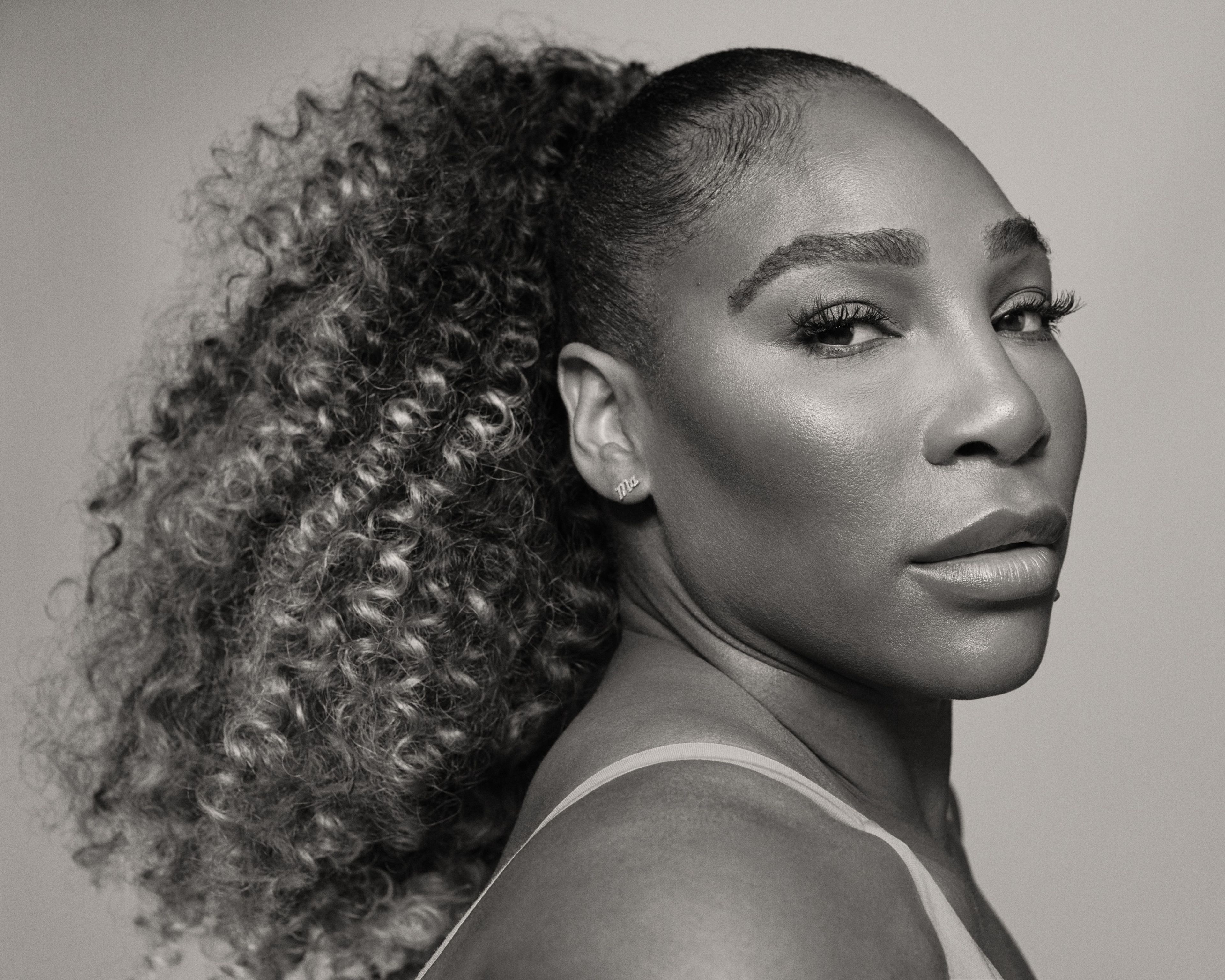 Black and white side angled view of Serena Williams.
