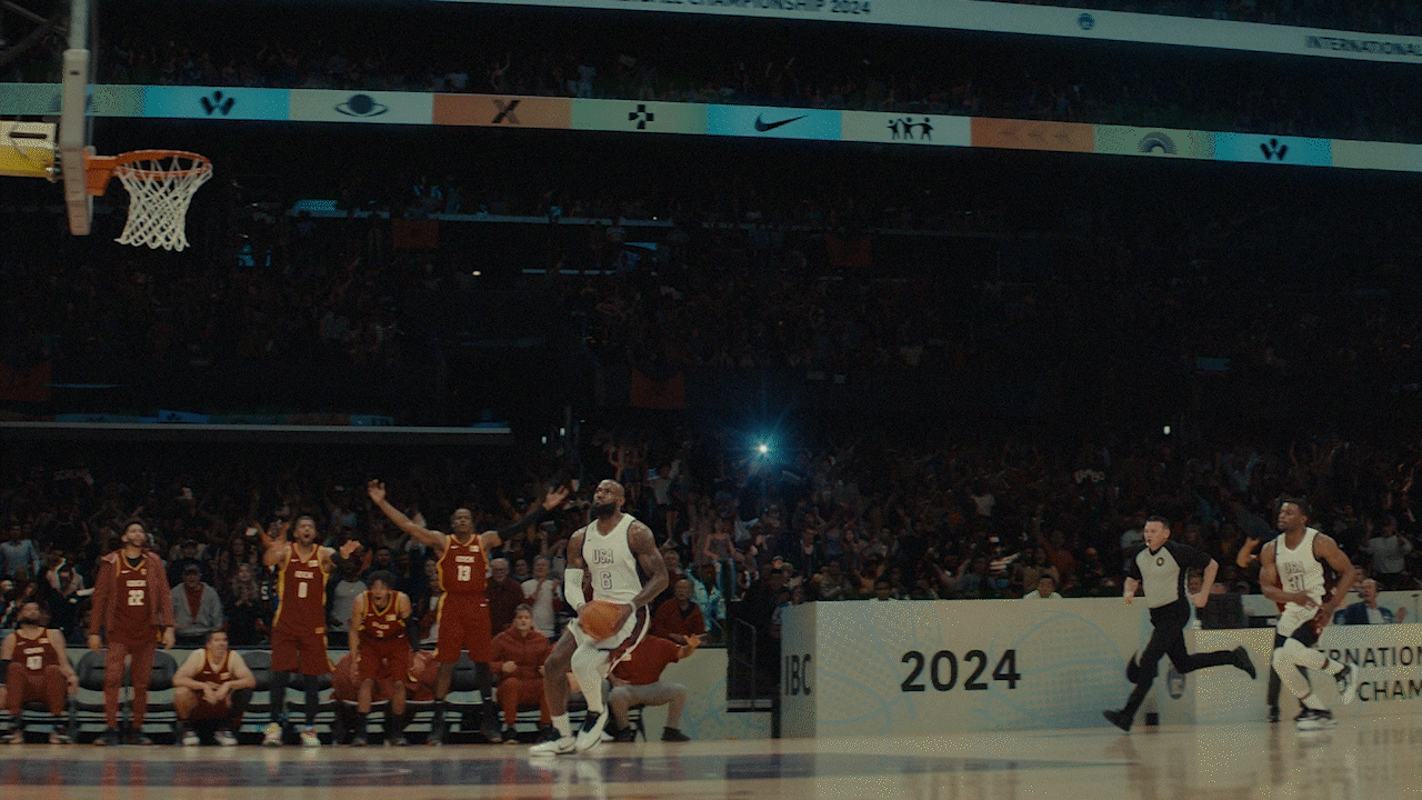 Video loop of Lebron James jumping up to the basket to dunk the ball. The loop runs in slow motion, making Lebron float above the court.